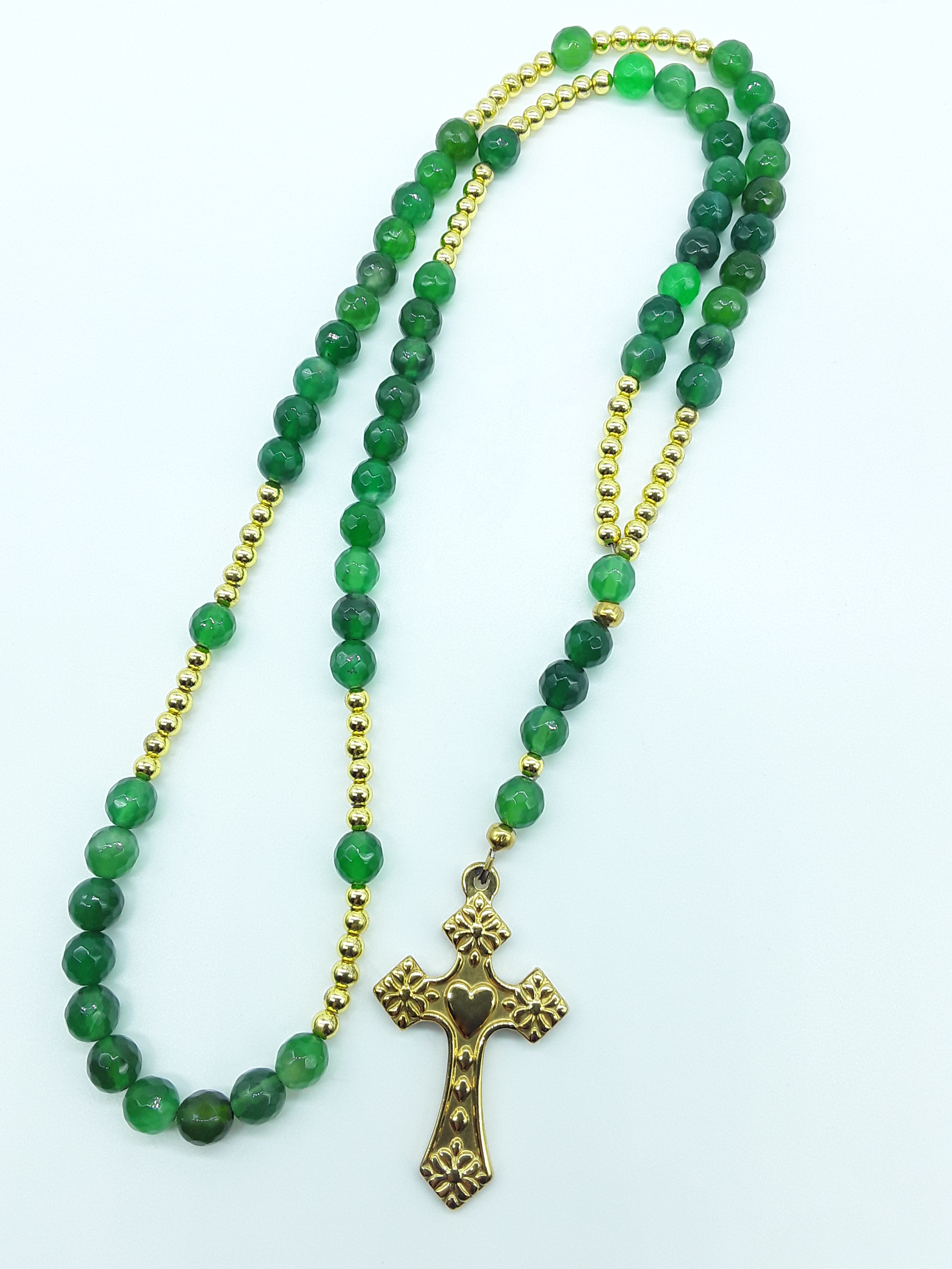 Catholic rosary with natural green agate beads, hematite elements, and a stainless steel heart-shaped cross shown in full length on a light background.
