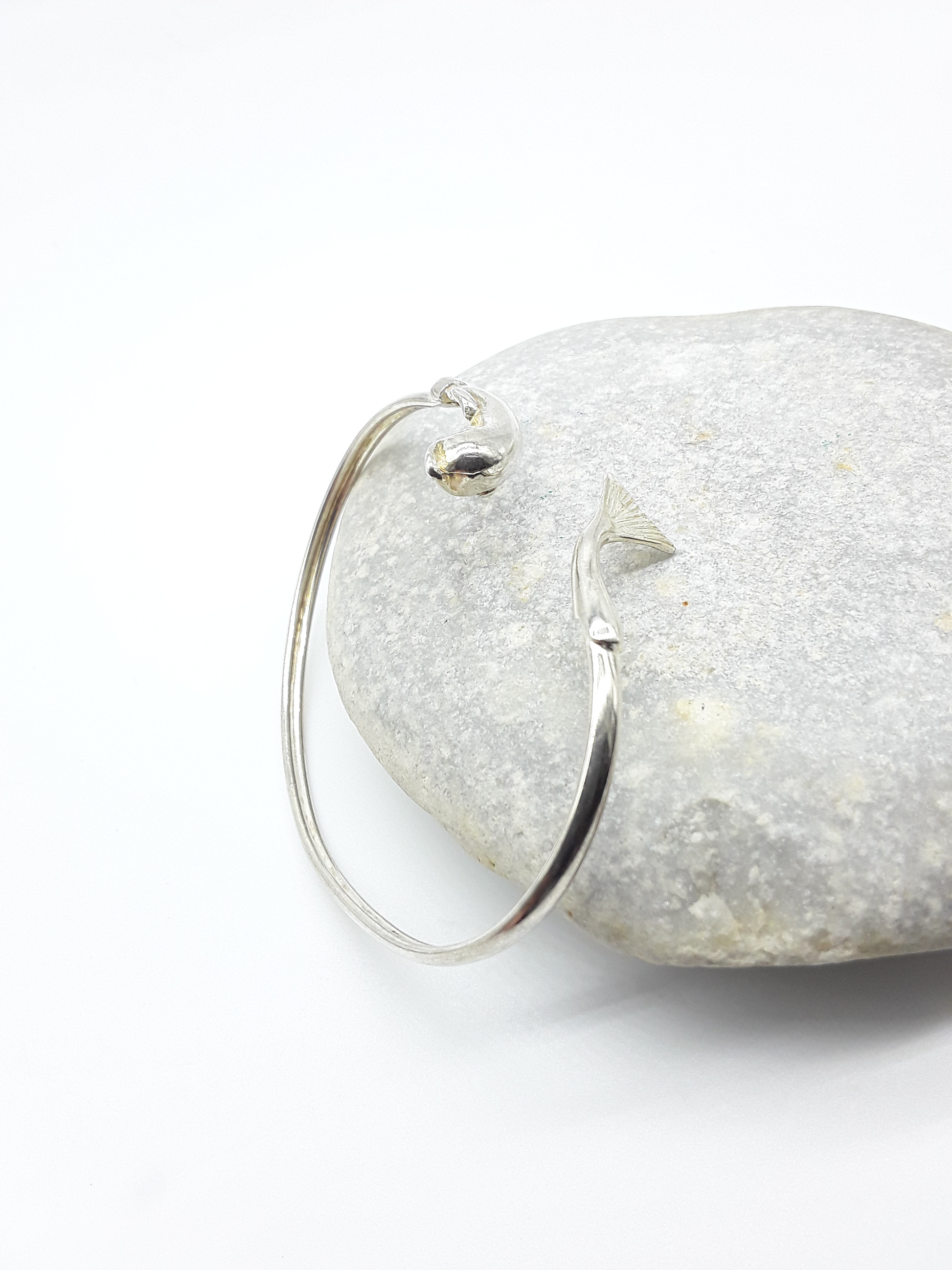 Silver dolphin bracelet photographed on natural stone — Polmadeva