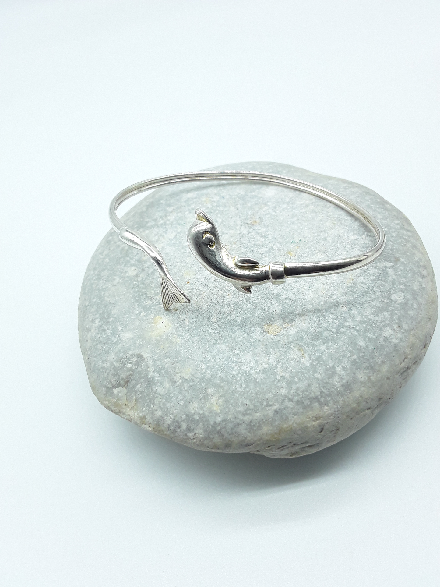 Silver dolphin bracelet photographed on natural stone — Polmadeva