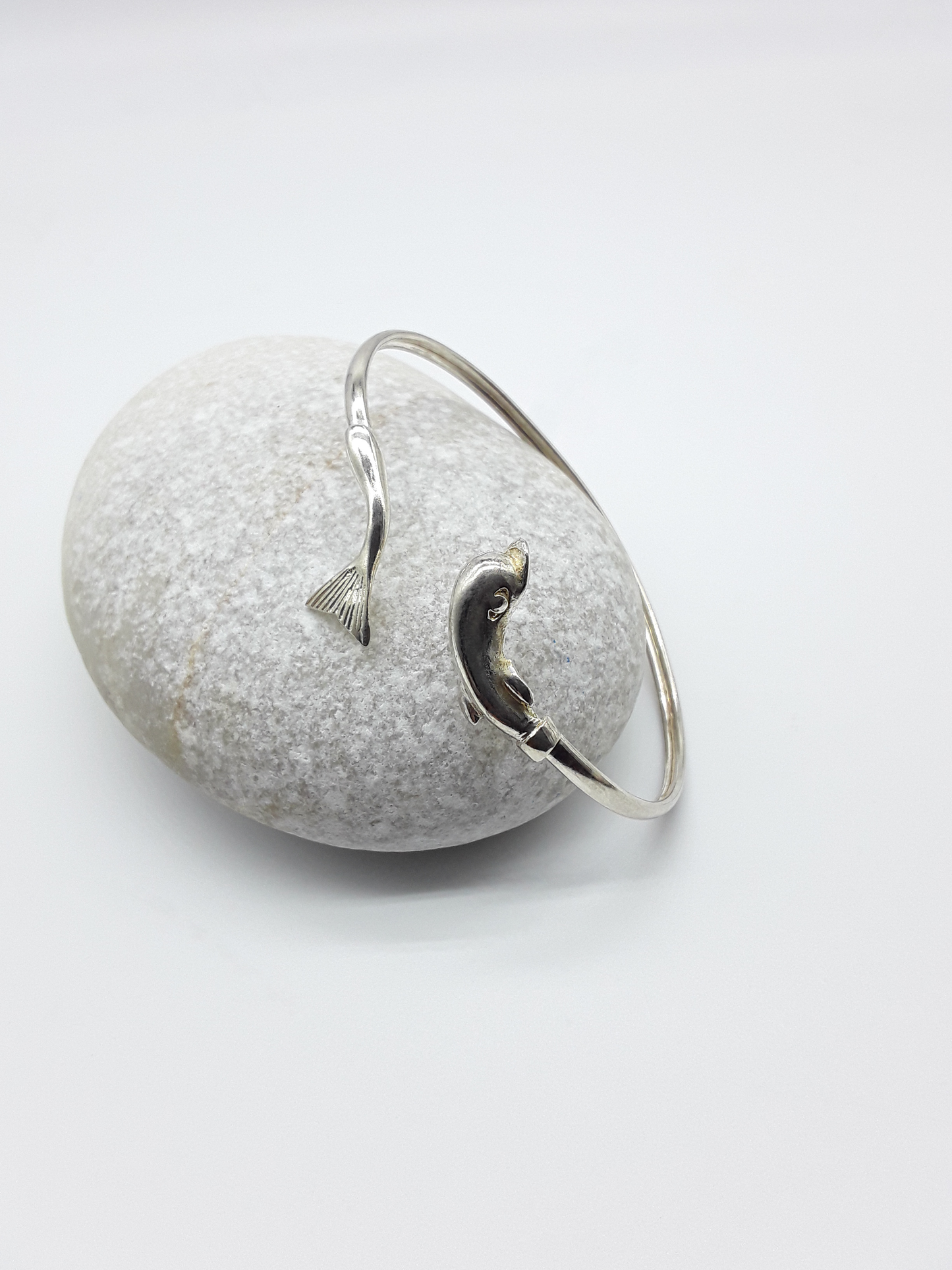 Silver dolphin bracelet photographed on natural stone — Polmadeva