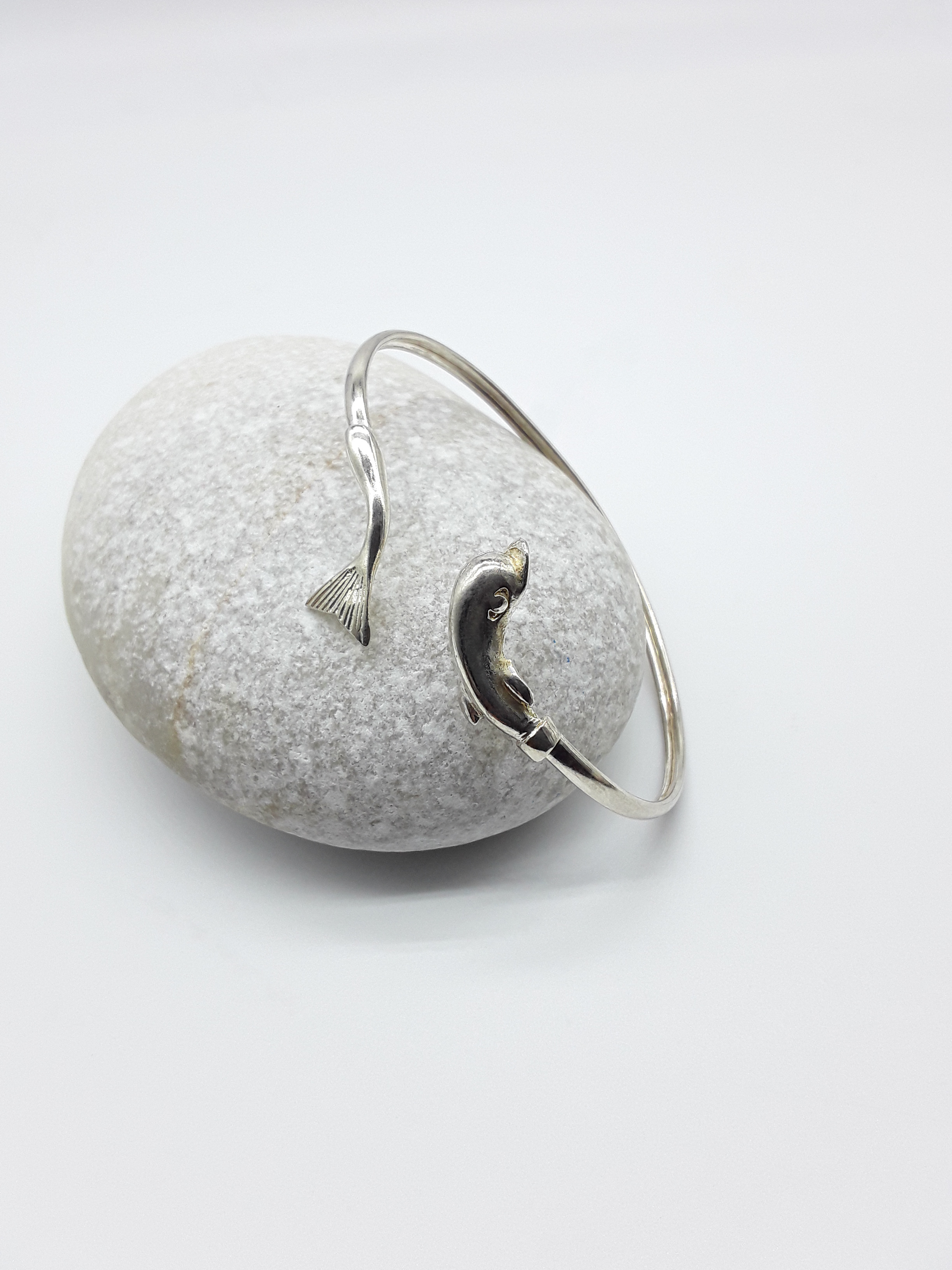 Silver dolphin bracelet photographed on natural stone — Polmadeva