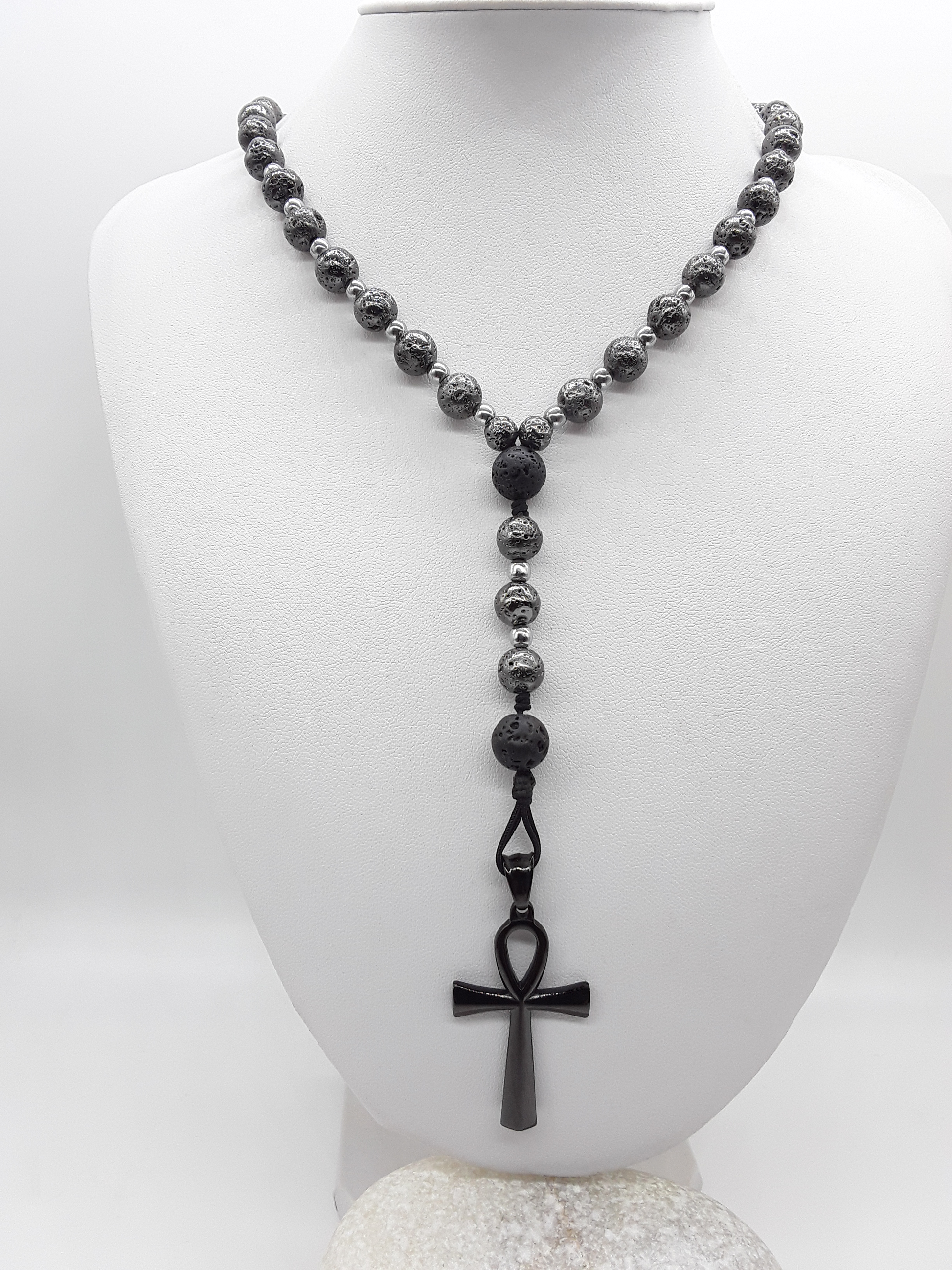 Forged in Continuity lava and hematite Catholic rosary with Ankh cross on white background by Polmadeva