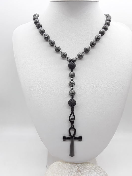 Forged in Continuity lava and hematite Catholic rosary with Ankh cross on white background by Polmadeva