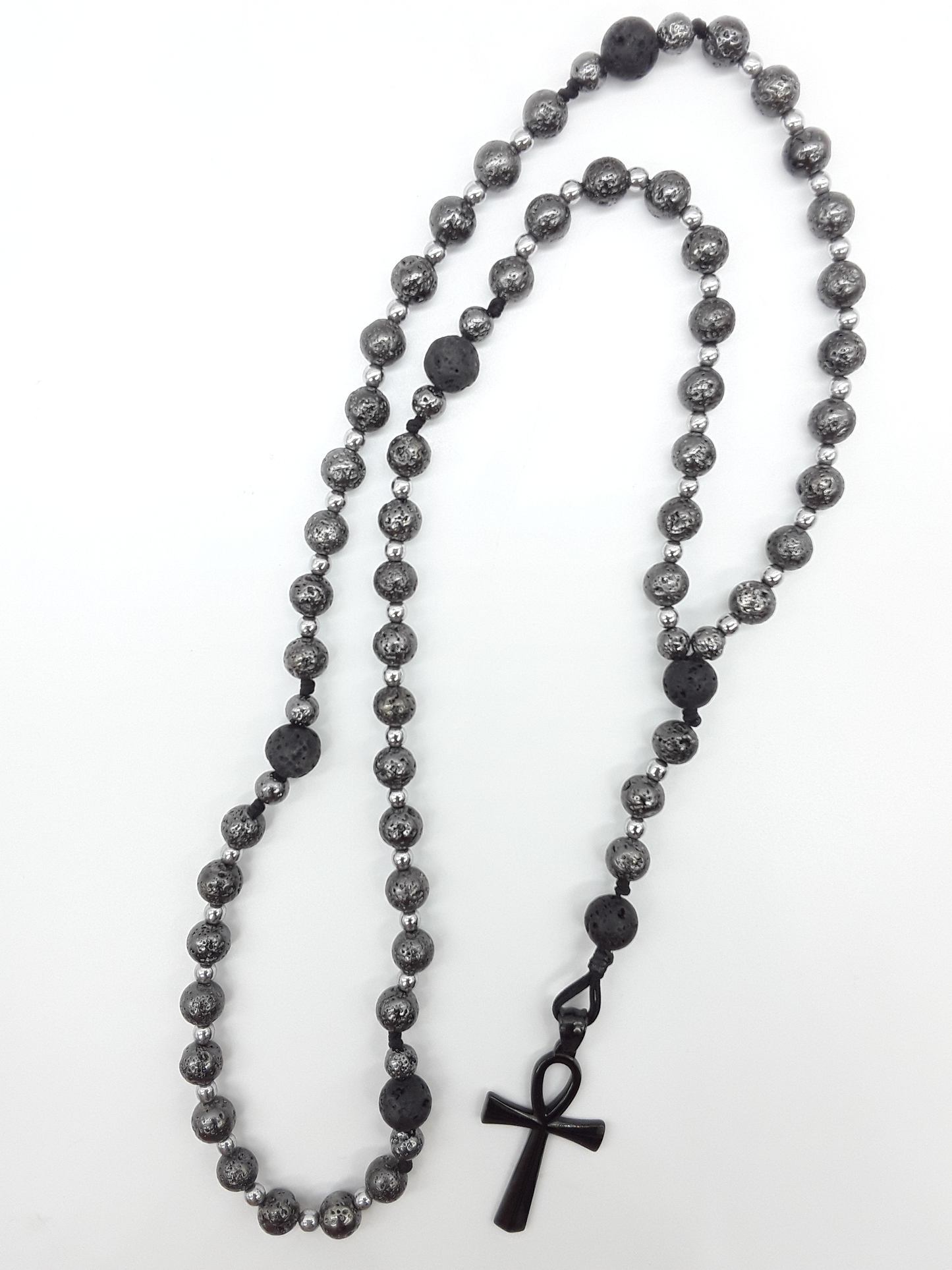 Forged in Continuity lava and hematite Catholic rosary with Ankh cross on white background by Polmadeva