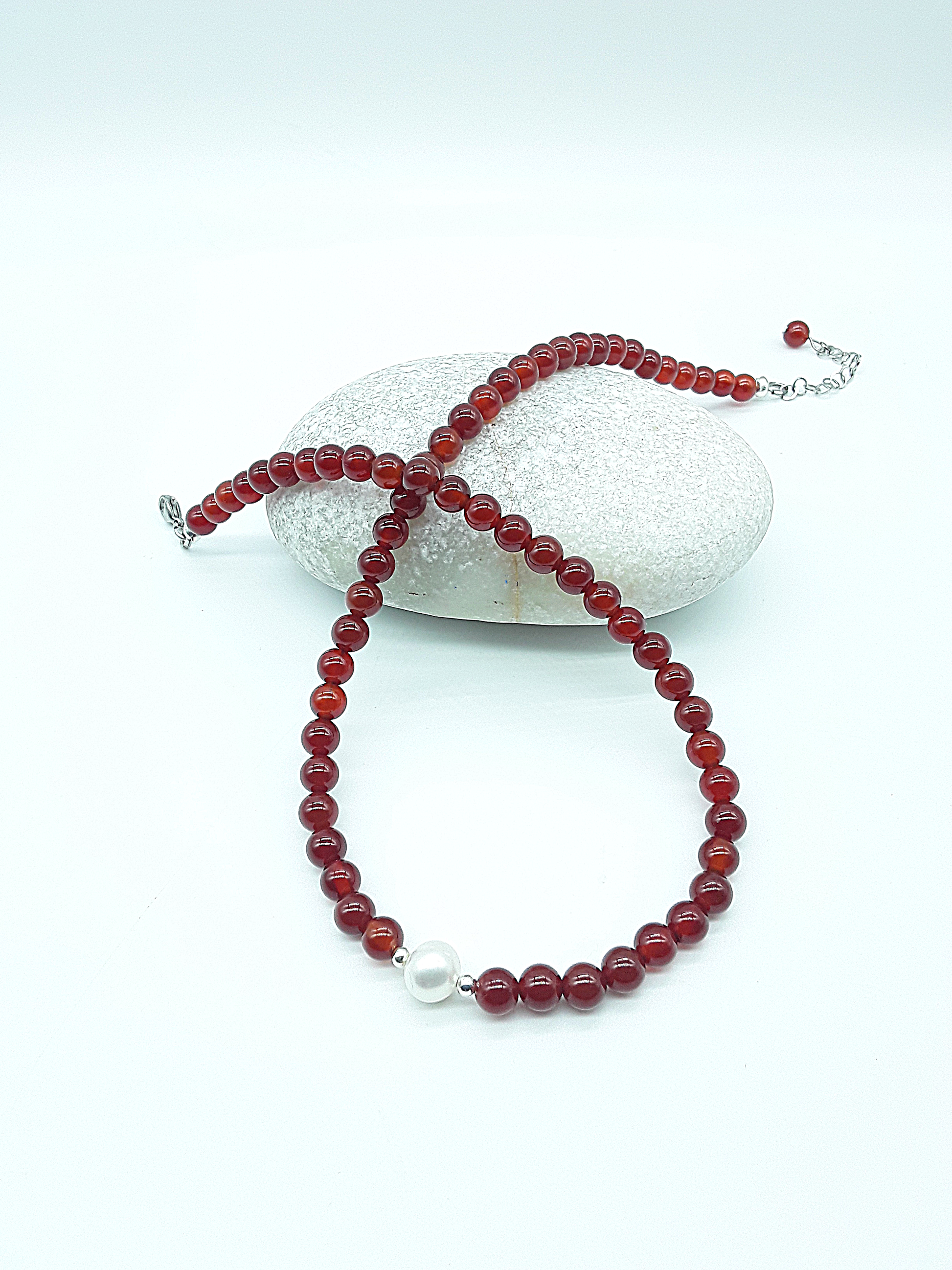 Heartfire Pearl Necklace by Polmadeva arranged in a circular form with red carnelian beads and freshwater pearl, Courage Rising collection
