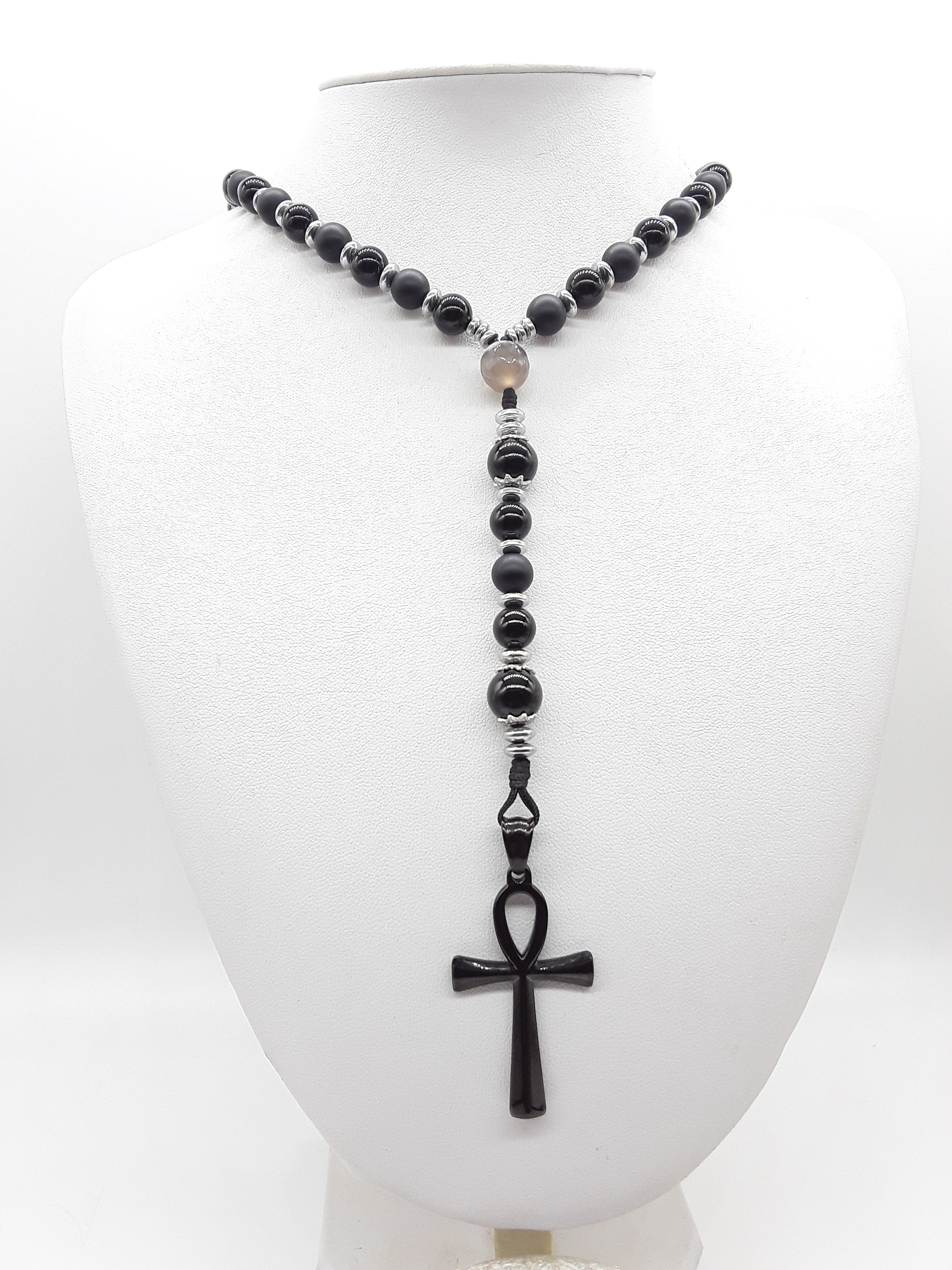 Held in Alignment — Onyx, Hematite & Agate Ankh Catholic Rosary (5 Decade) by Polmadeva with black stainless steel Ankh cross on white background.