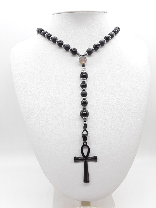 Held in Alignment — Onyx, Hematite & Agate Ankh Catholic Rosary (5 Decade) by Polmadeva with black stainless steel Ankh cross on white background.