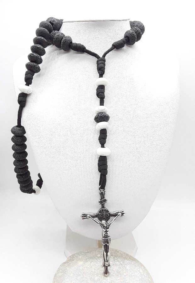 Black rosary with a silver crucifix on a white background