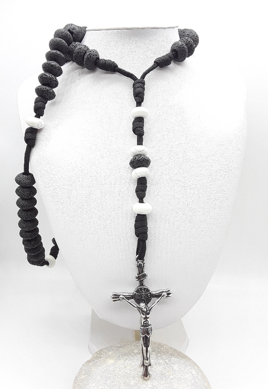 Black rosary with a silver crucifix on a white background