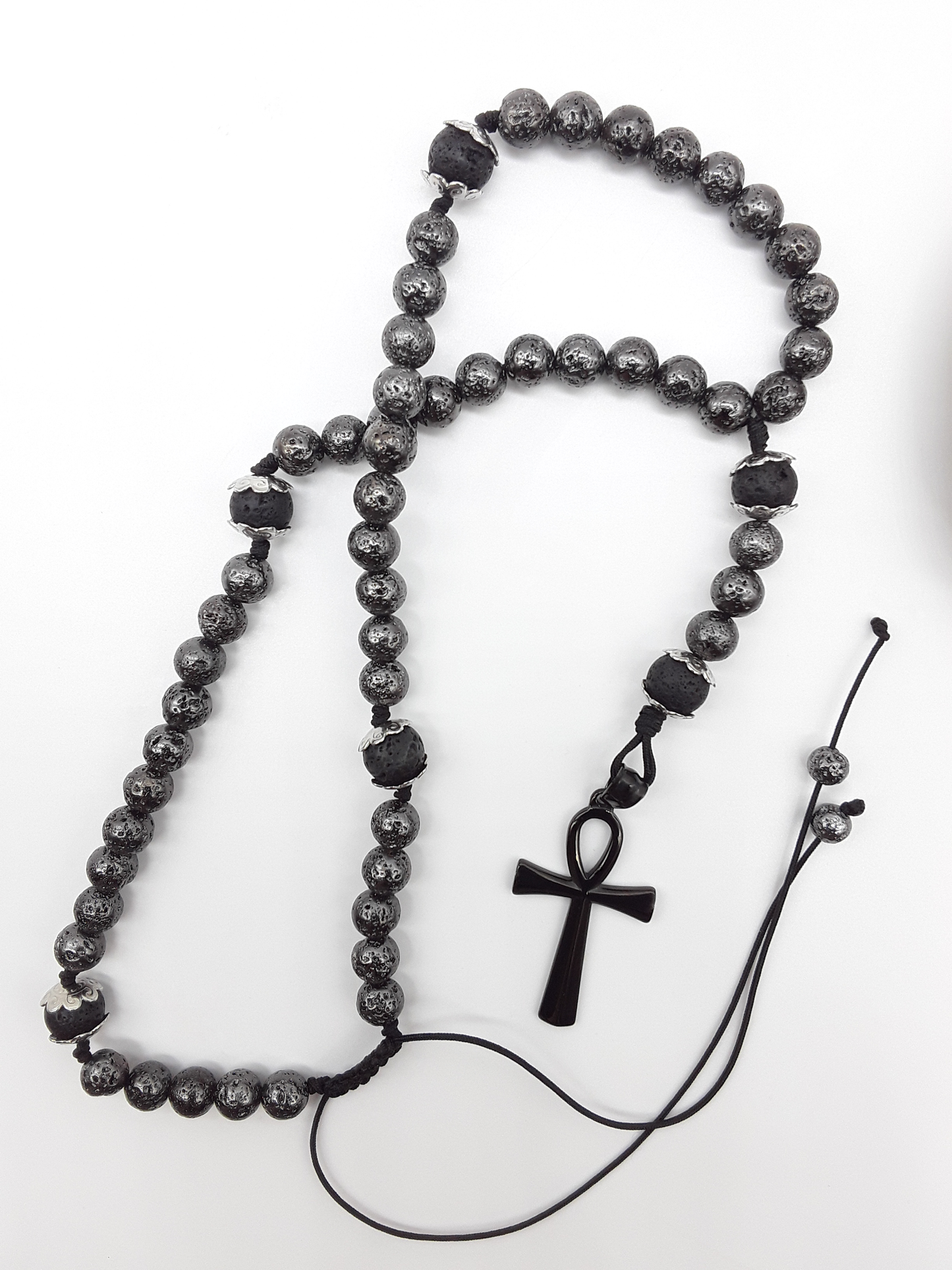 Held in Continuity — Galvanized Lava & Silver Ankh Catholic Rosary (5 Decade) by Polmadeva with black stainless steel Ankh cross on white background.