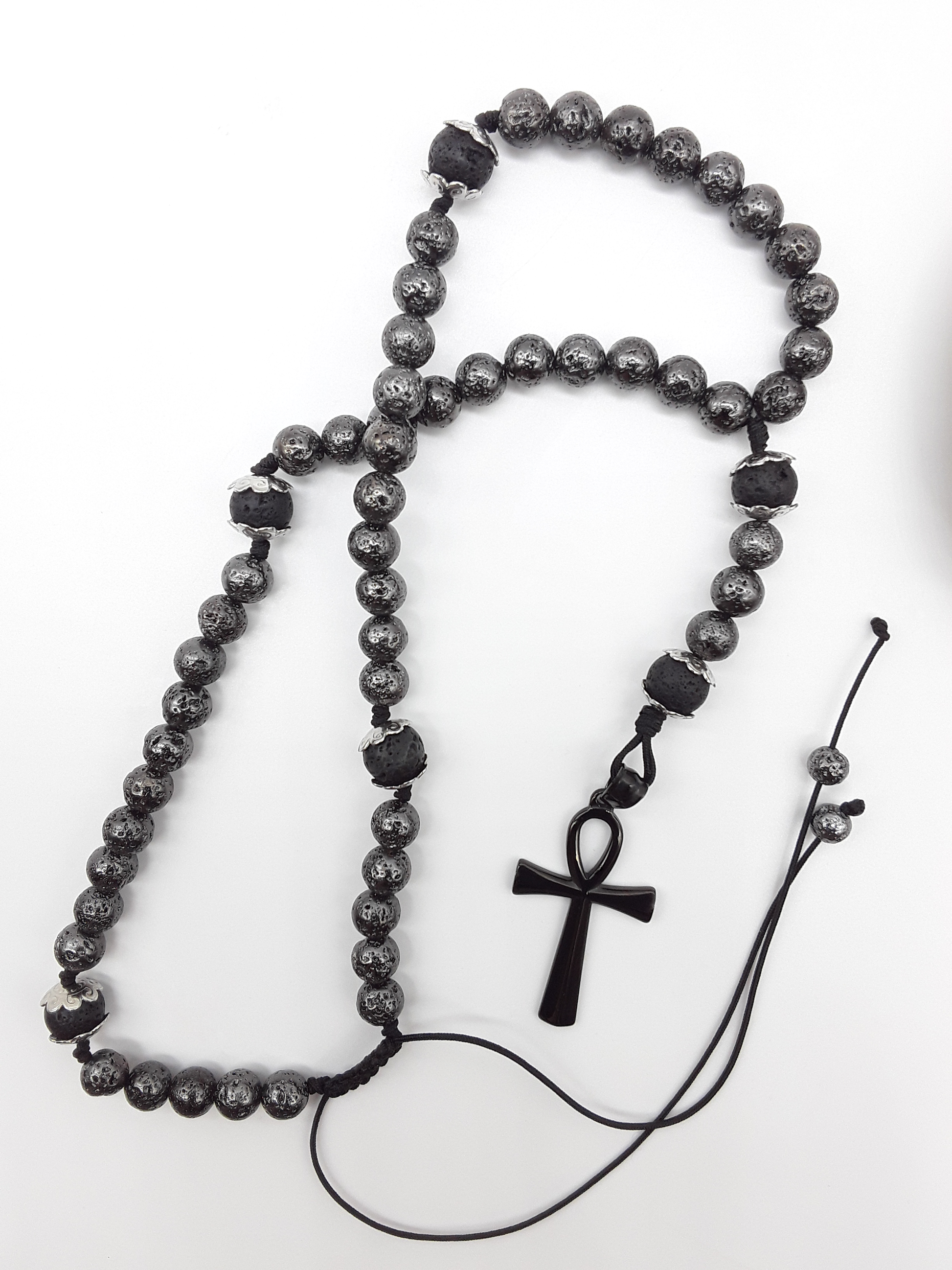 Held in Continuity — Galvanized Lava & Silver Ankh Catholic Rosary (5 Decade) by Polmadeva with black stainless steel Ankh cross on white background.