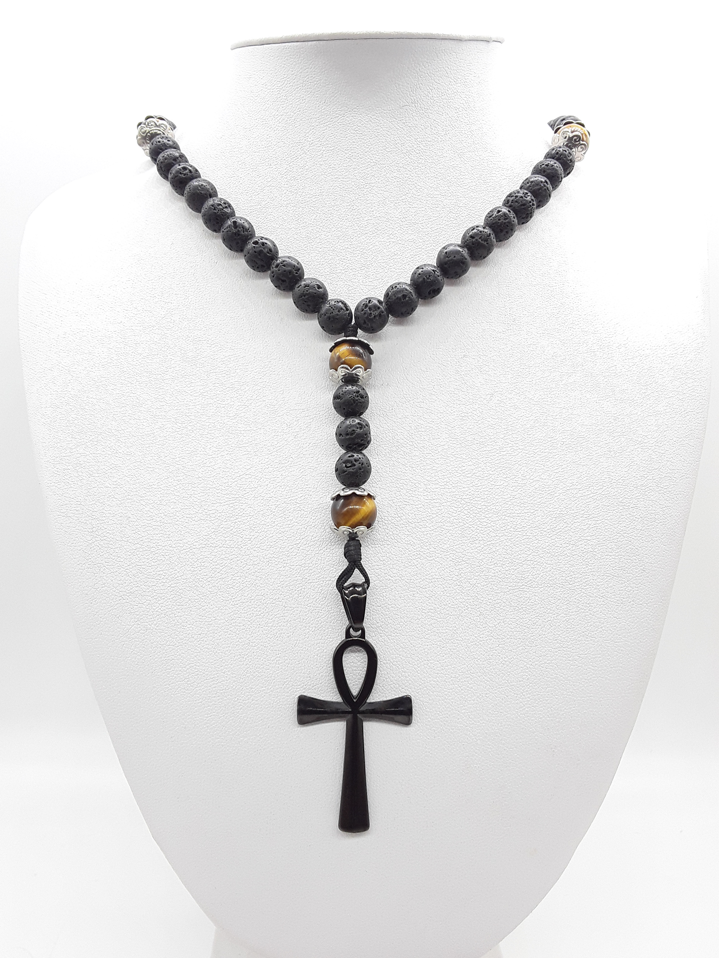 Held in Direction — Lava & Tiger’s Eye Ankh Catholic Rosary (5 Decade) by Polmadeva with black stainless steel Ankh cross on white background.
