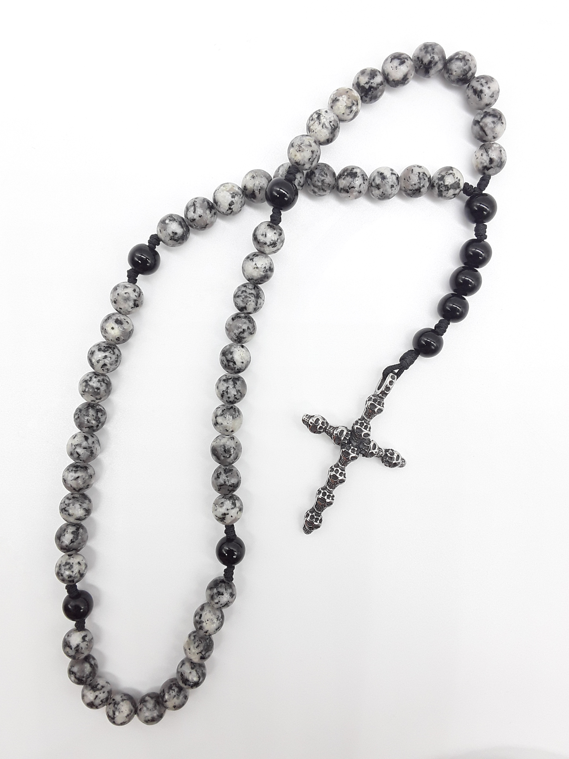 Pocket Catholic Rosary with jasper and black onyx beads and textured stainless steel cross on white background.