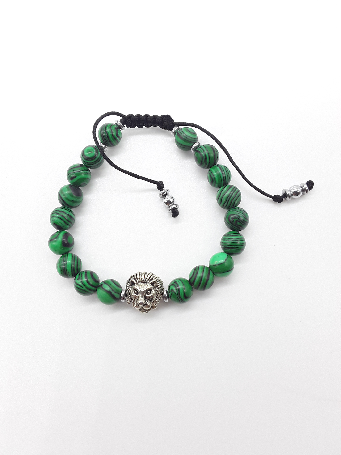 Malachite beaded lion bracelet with hematite accents on a white background