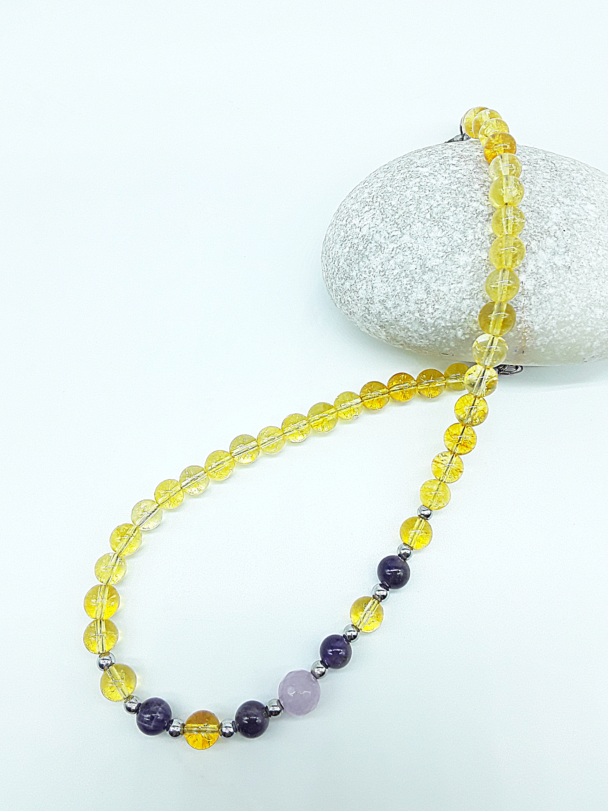Luminous Ascent Necklace by Polmadeva with citrine, amethyst, rose quartz and hematite gemstones, symbolizing luminous ascent and inner balance.