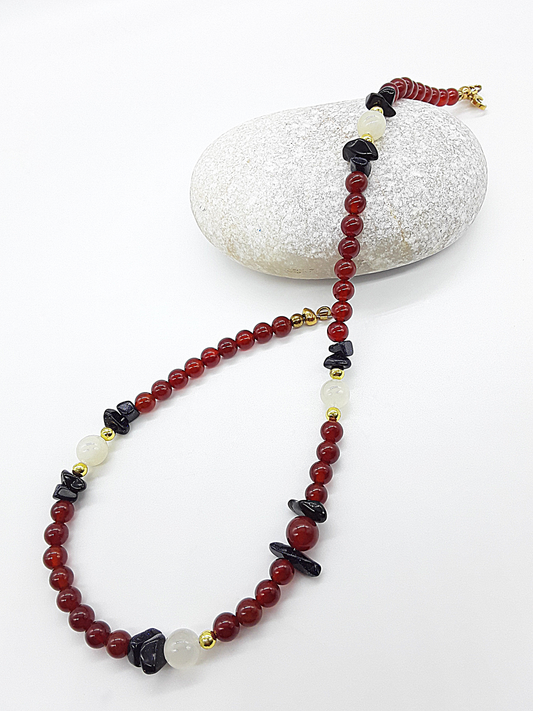 Nightfall Renewal Necklace by Polmadeva laid flat with carnelian beads, moonstone and blue goldstone, Begin Again collection