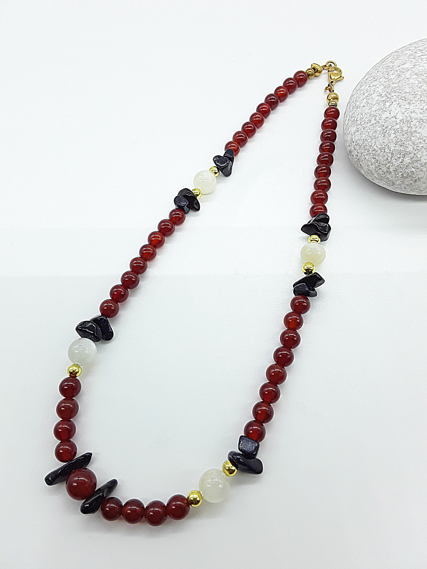 Nightfall Renewal Necklace by Polmadeva laid flat with a balanced flowing line of carnelian beads, moonstone and blue goldstone, Begin Again collection