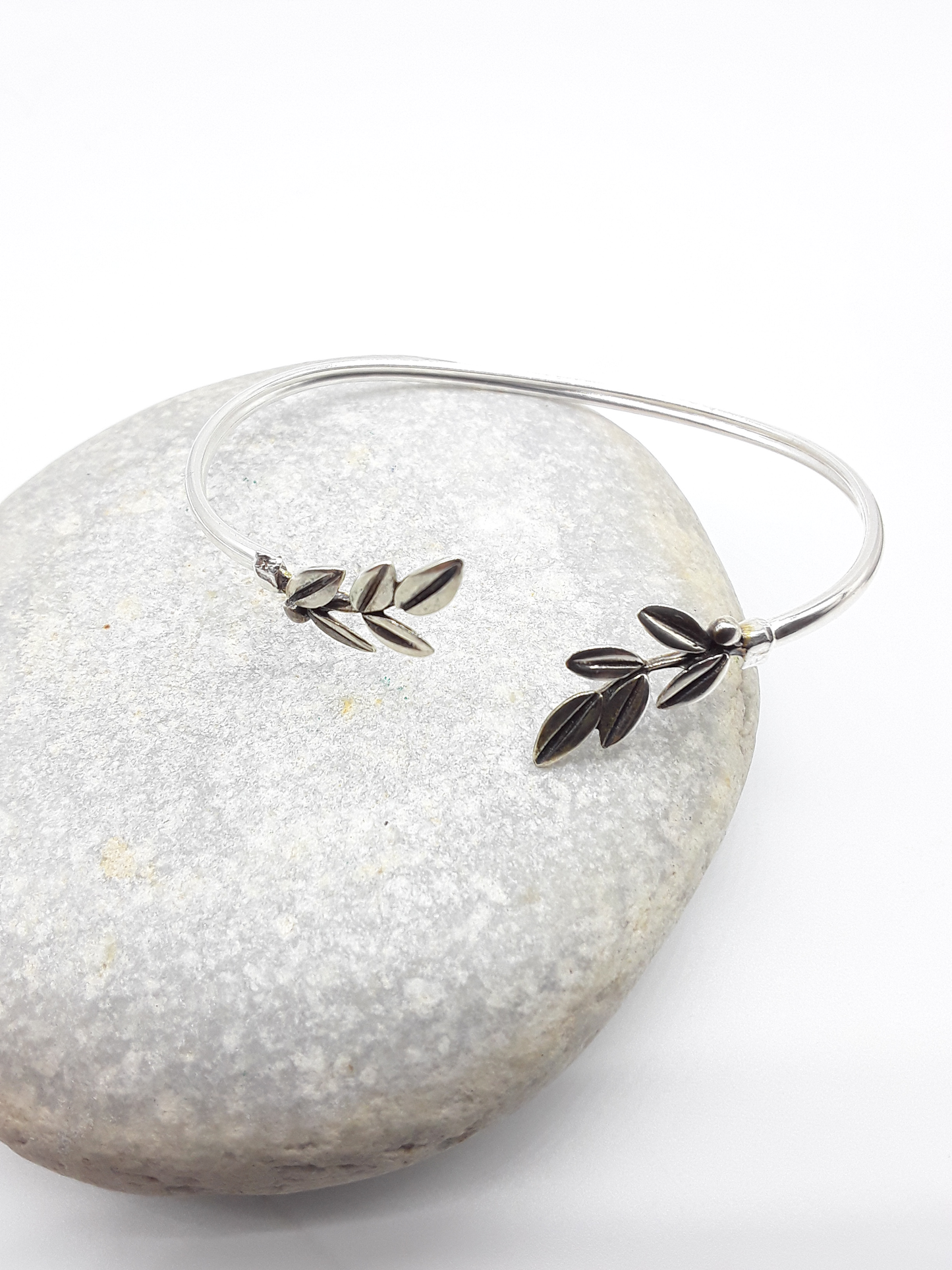 Silver olive branch bracelet photographed on natural stone — Polmadeva