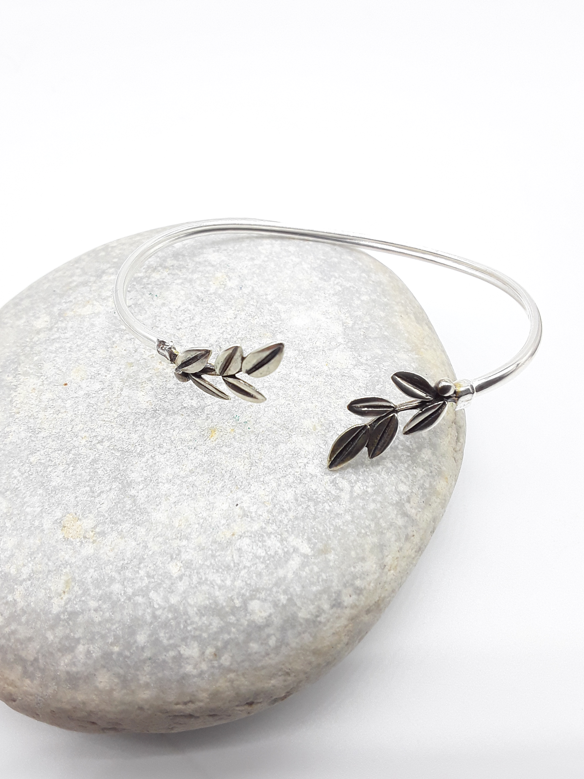 Silver olive branch bracelet photographed on natural stone — Polmadeva