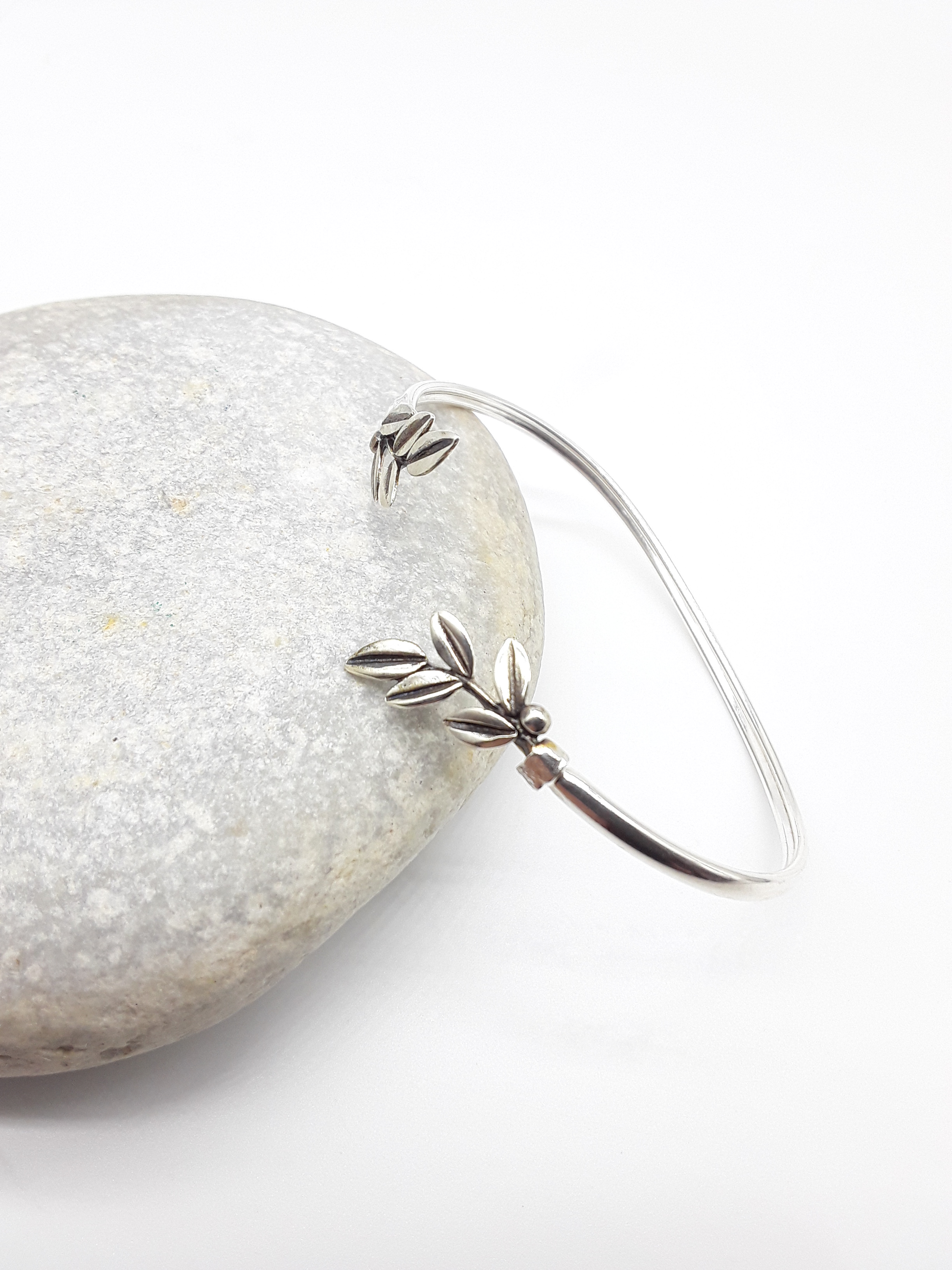 Silver olive branch bracelet photographed on natural stone — Polmadeva