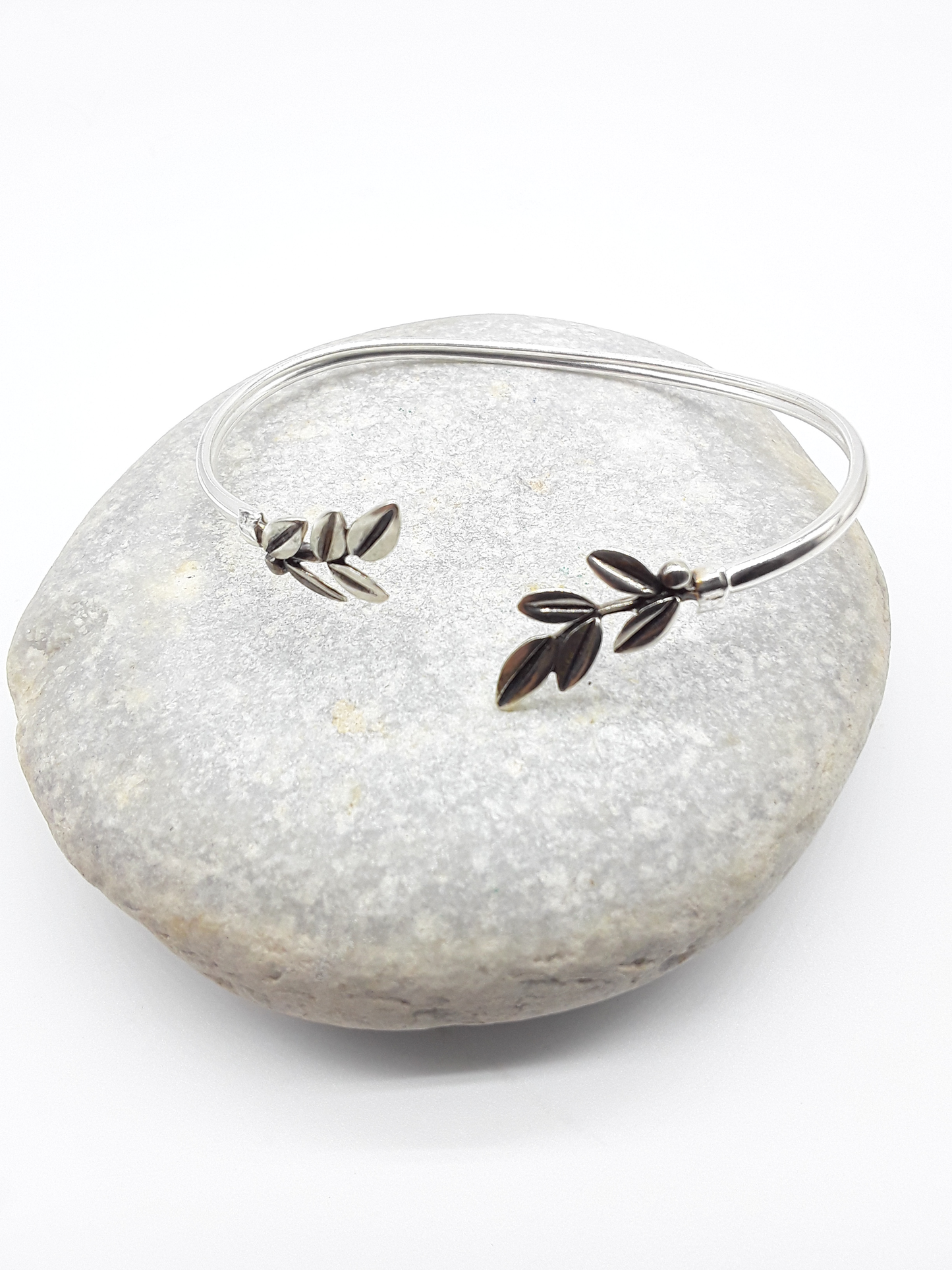 Silver olive branch bracelet photographed on natural stone — Polmadeva