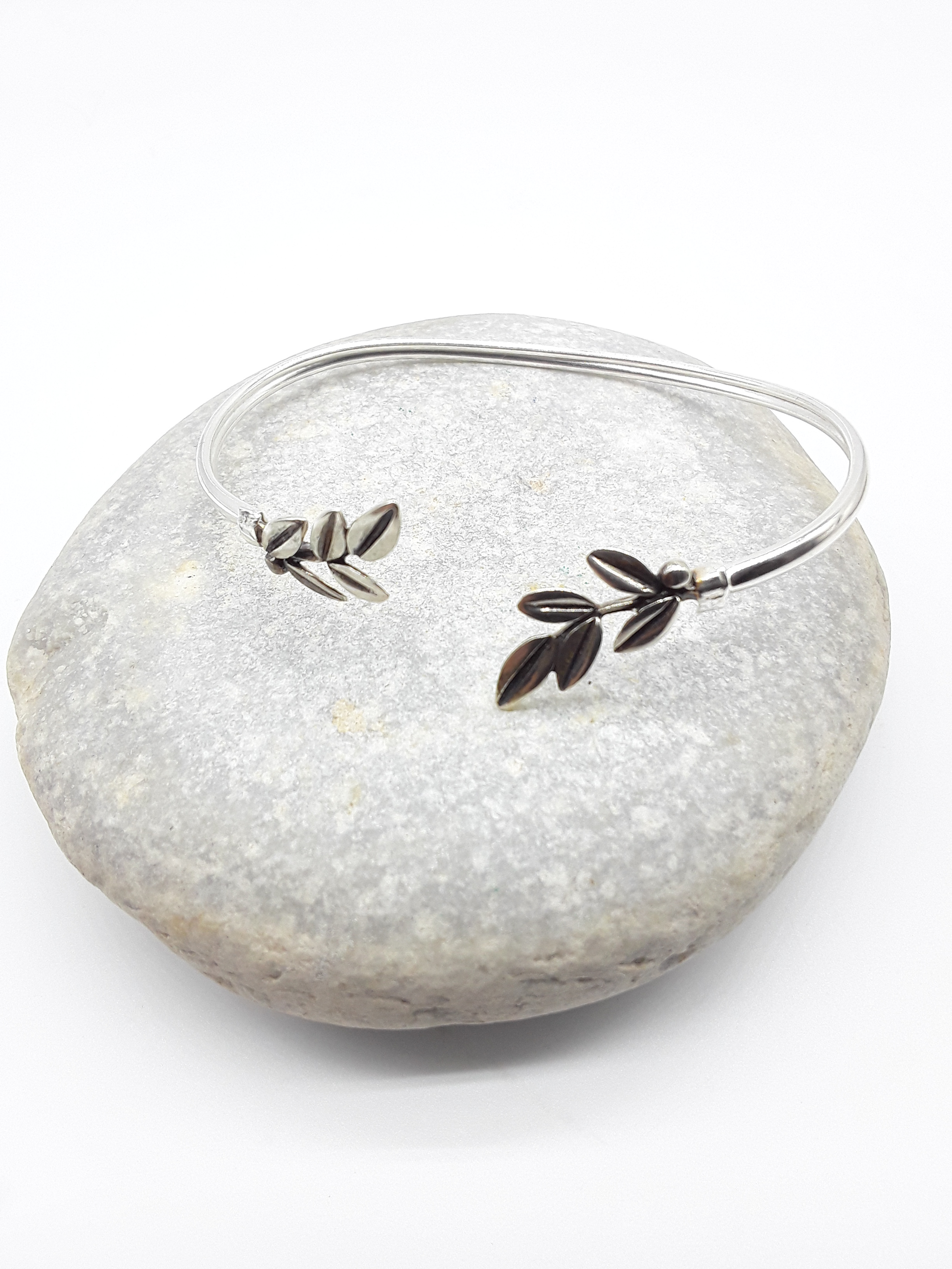 Silver olive branch bracelet photographed on natural stone — Polmadeva