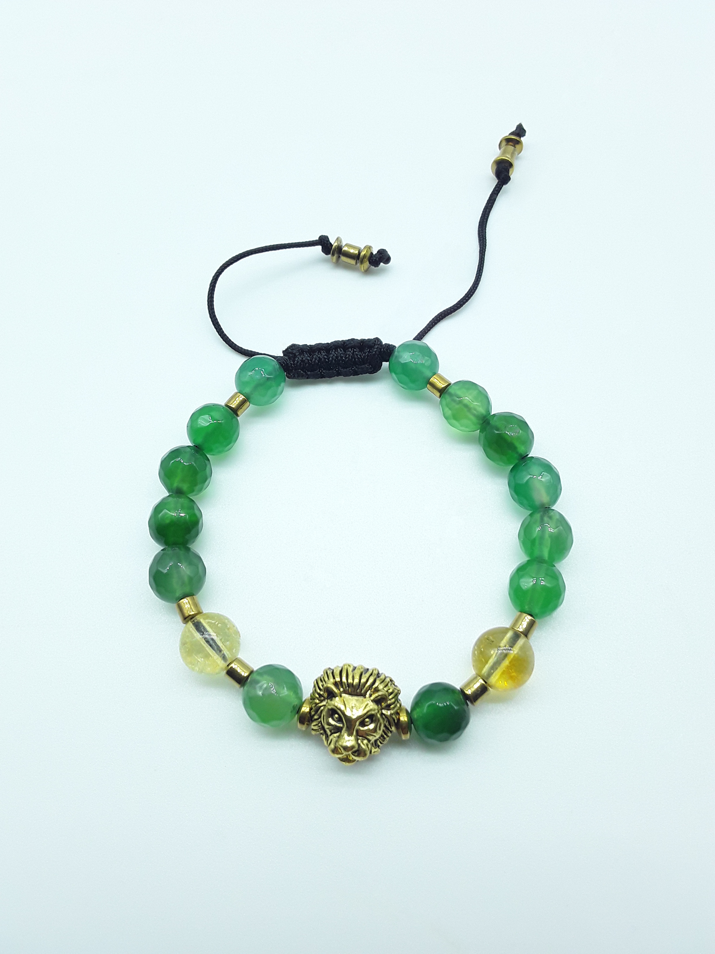 Quiet Ascent Lion Bracelet by Polmadeva with citrine, green agate and hematite beads on a white background
