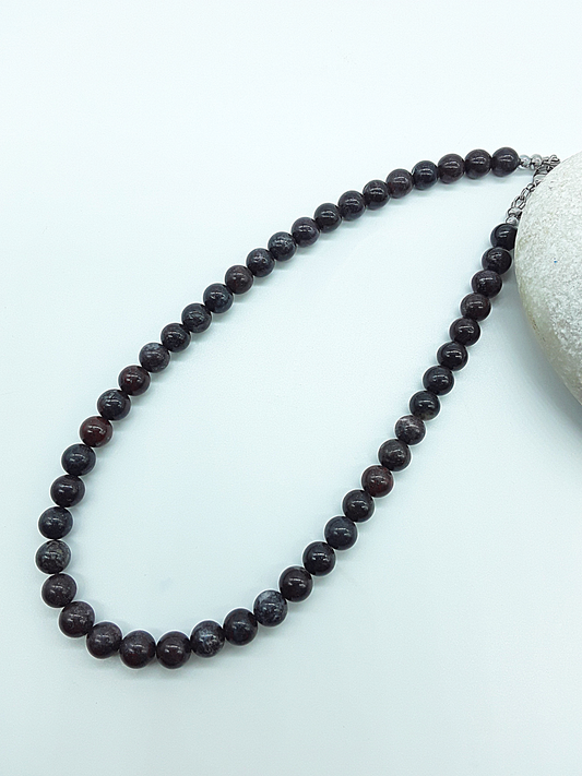 Stone of Resolve Necklace with natural bloodstone beads laid flat, handcrafted gemstone talisman by Polmadeva from the Quiet Power collection