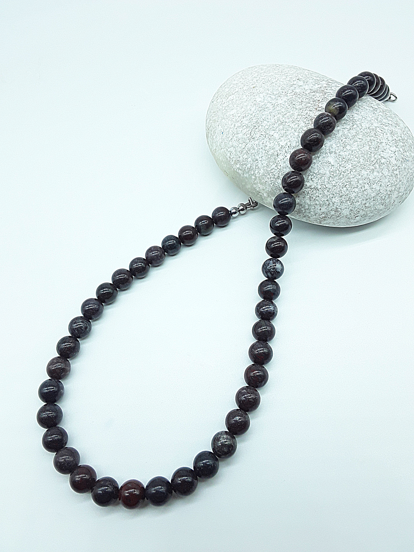 Stone of Resolve Necklace featuring bloodstone beads styled on stone, Polmadeva Quiet Power collection