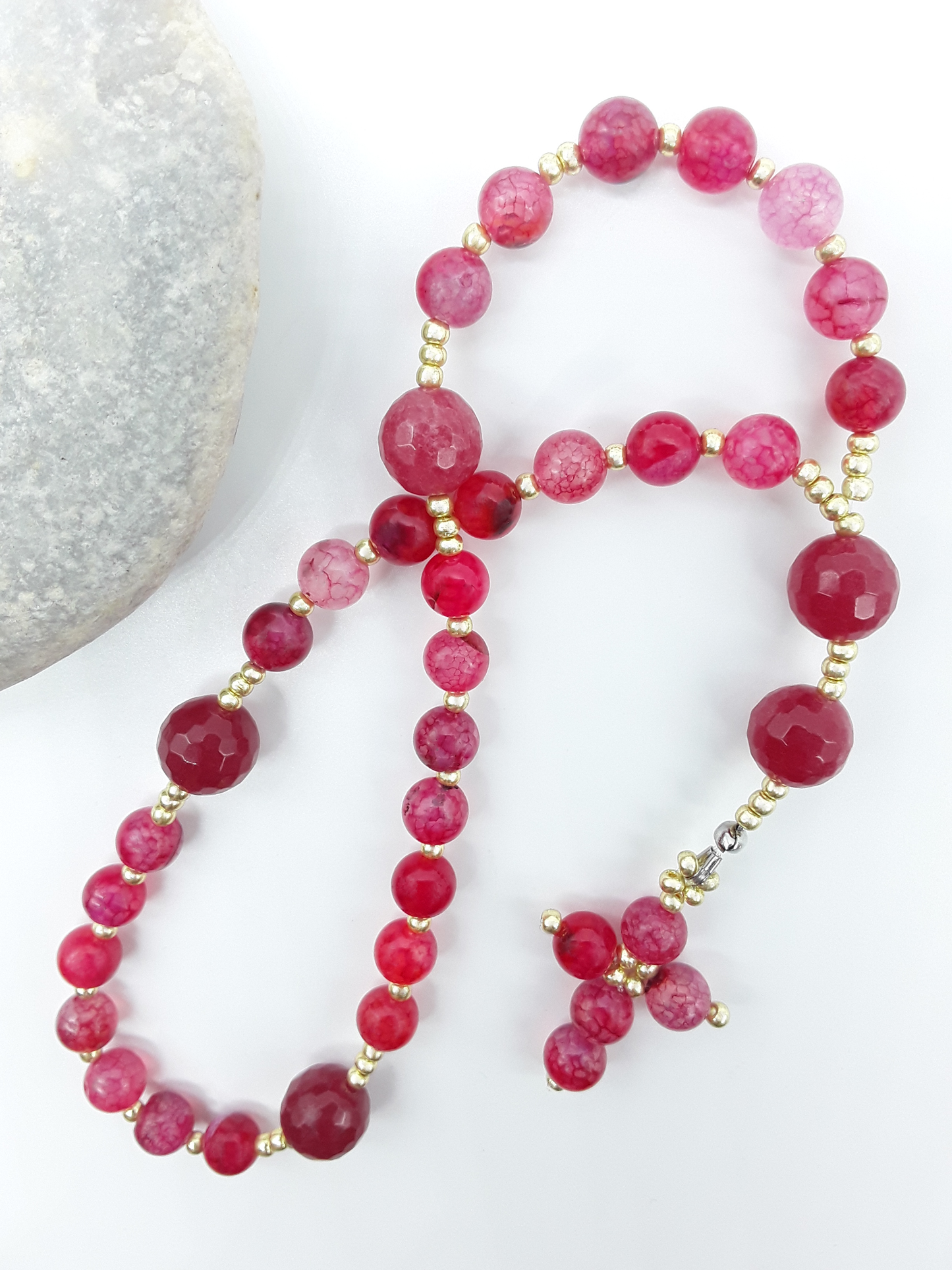 The Burning Hymn Anglican Prayer Beads by Polmadeva beside natural stone, featuring Dragon Vein beads, Agate, and Miyuki details