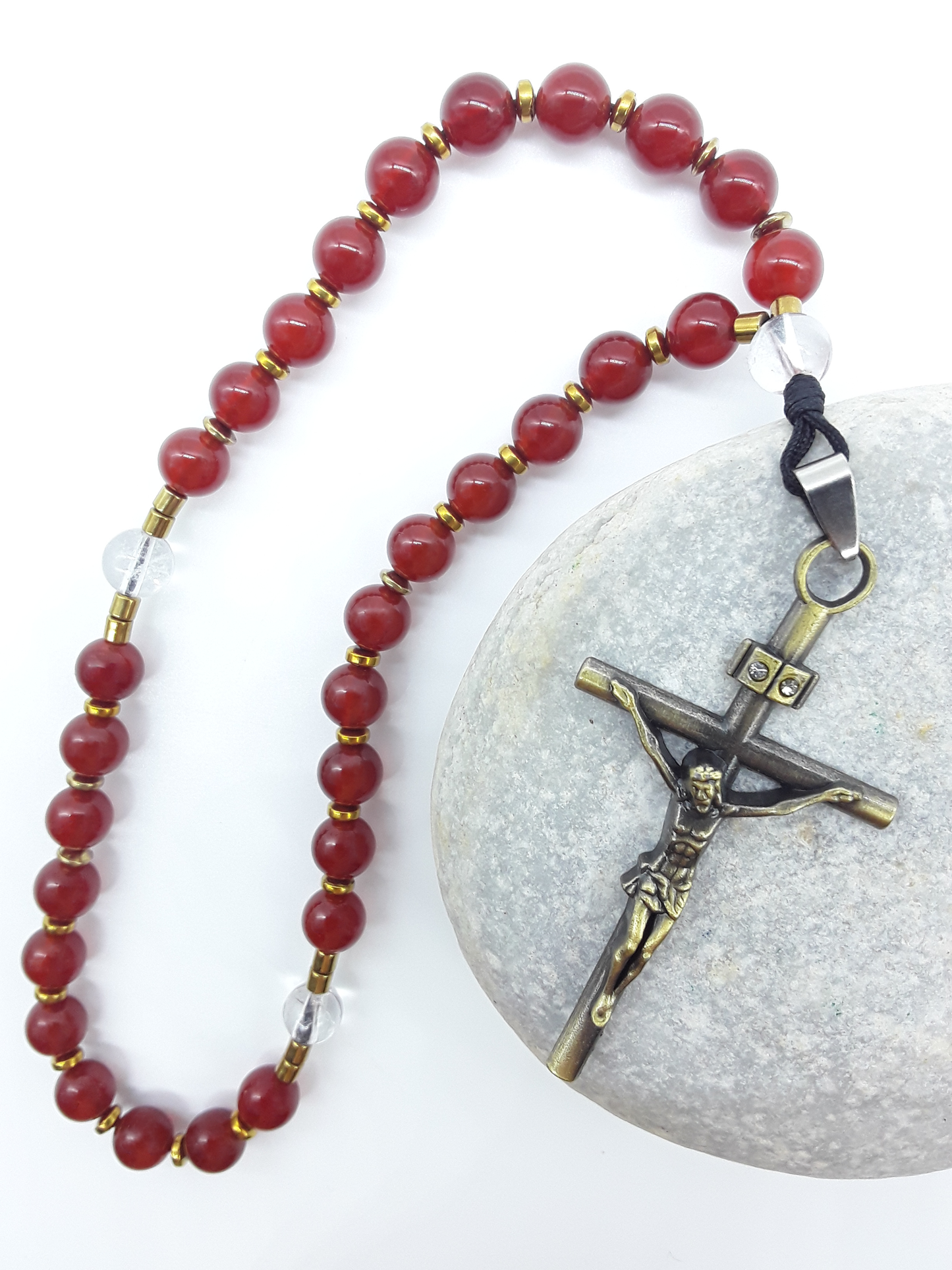 Burning Stillness Carnelian Orthodox Rosary resting on stone, bronze cross with zircon, by Polmadeva