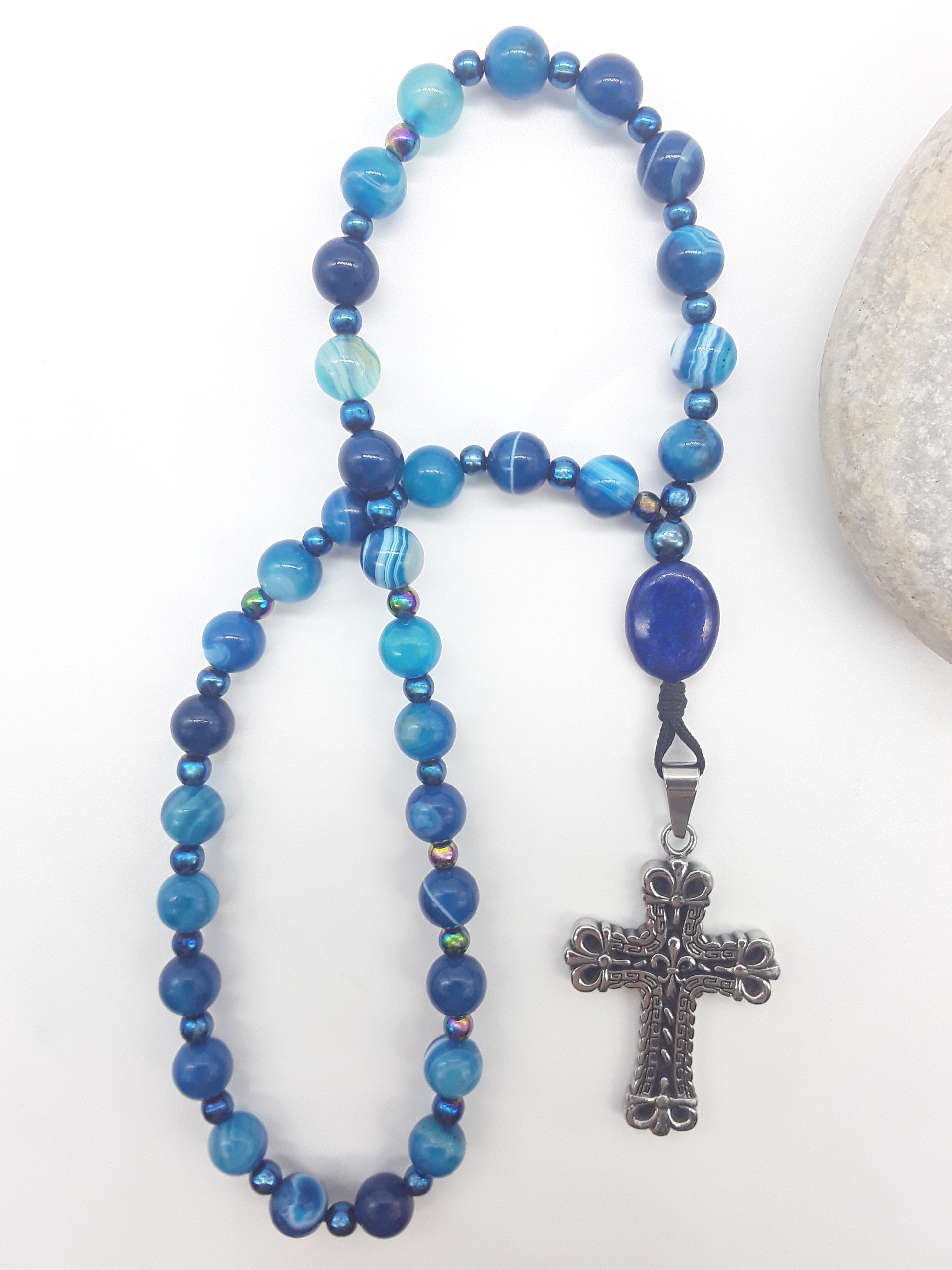 Agate and lapis lazuli Orthodox rosary with stainless steel cross placed beside natural stone, The Deep Stillness by Polmadeva
