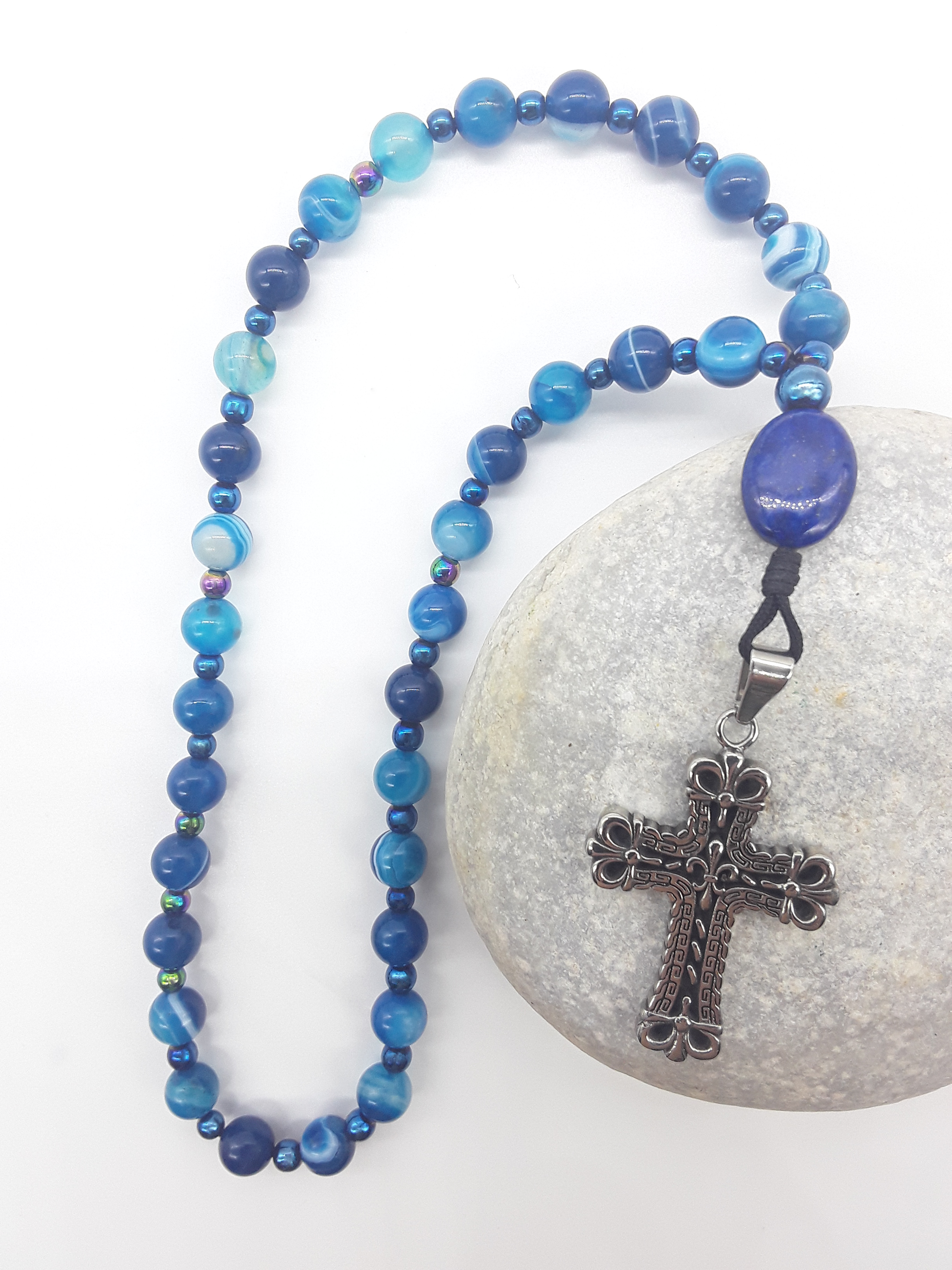 Agate and lapis lazuli Orthodox rosary with stainless steel cross resting on stone surface, The Deep Stillness by Polmadeva