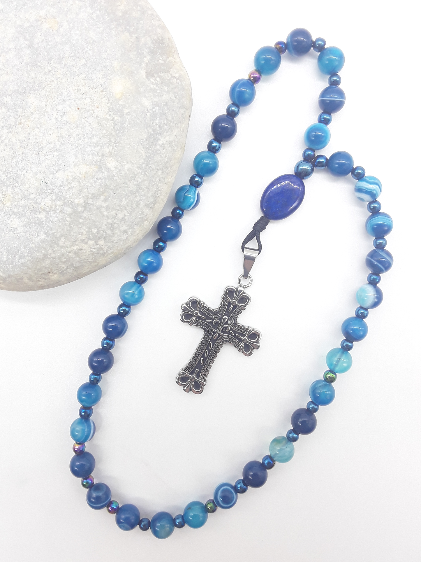 Agate and lapis lazuli Orthodox rosary with stainless steel cross placed beside natural stone, The Deep Stillness by Polmadeva