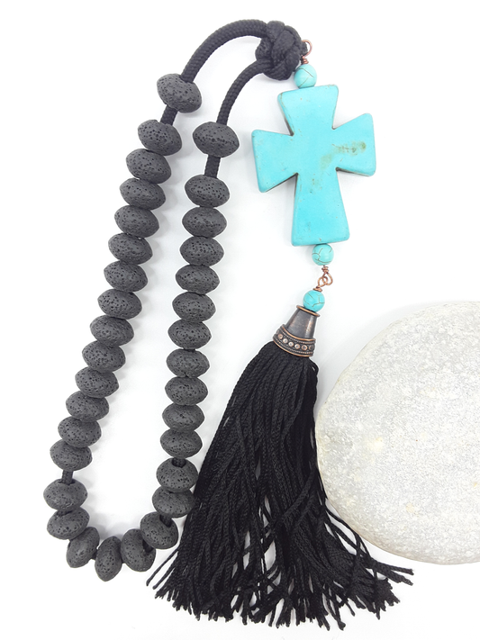 Lava and Howlite Orthodox Paracord Rosary with tassel beside natural stone surface by Polmadeva.