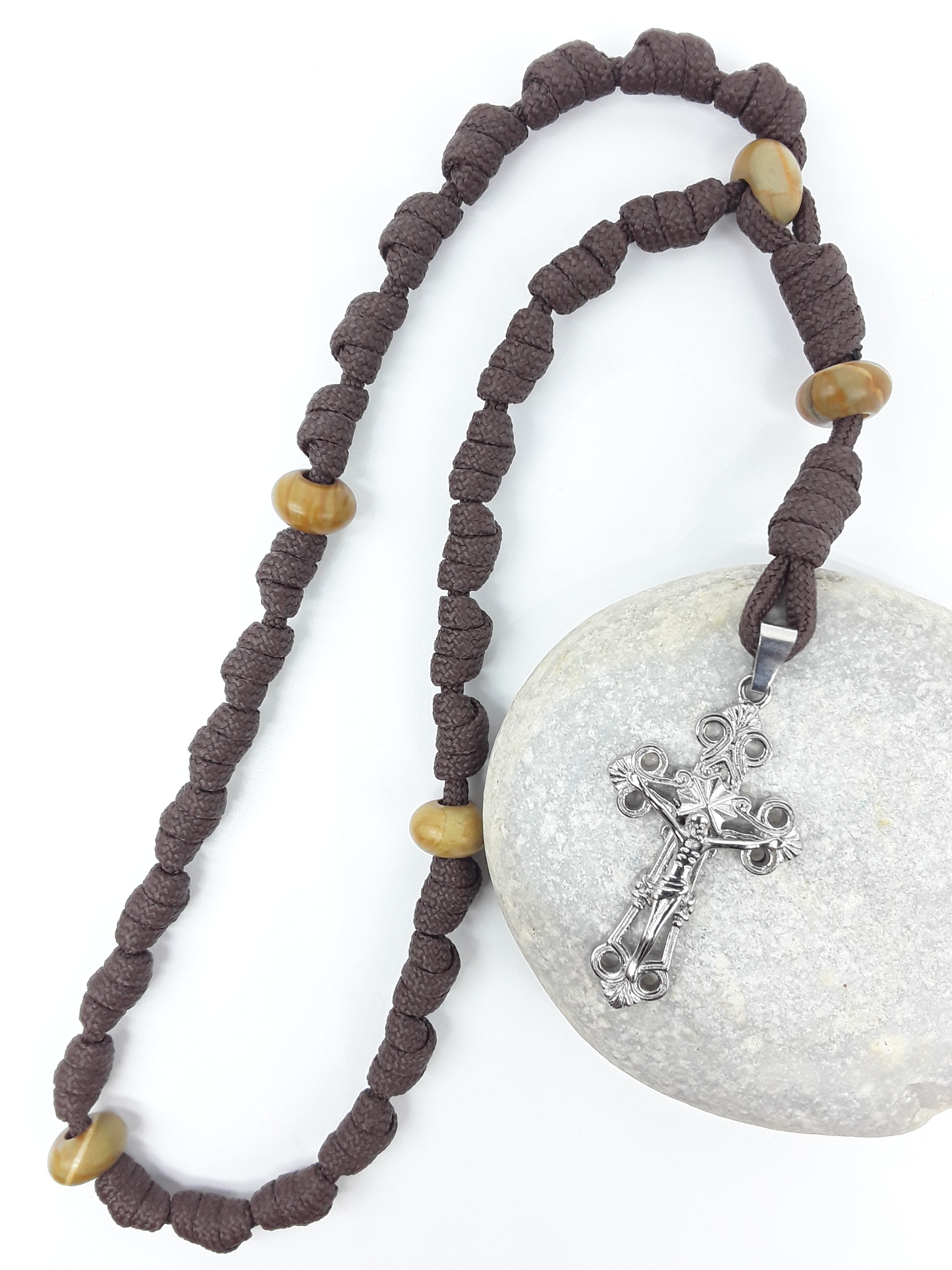 The Enduring Light Anglican Rosary by Polmadeva with hand-knotted brown paracord, Natural Wood elements, and Eternal Circle Crucifix on stone.