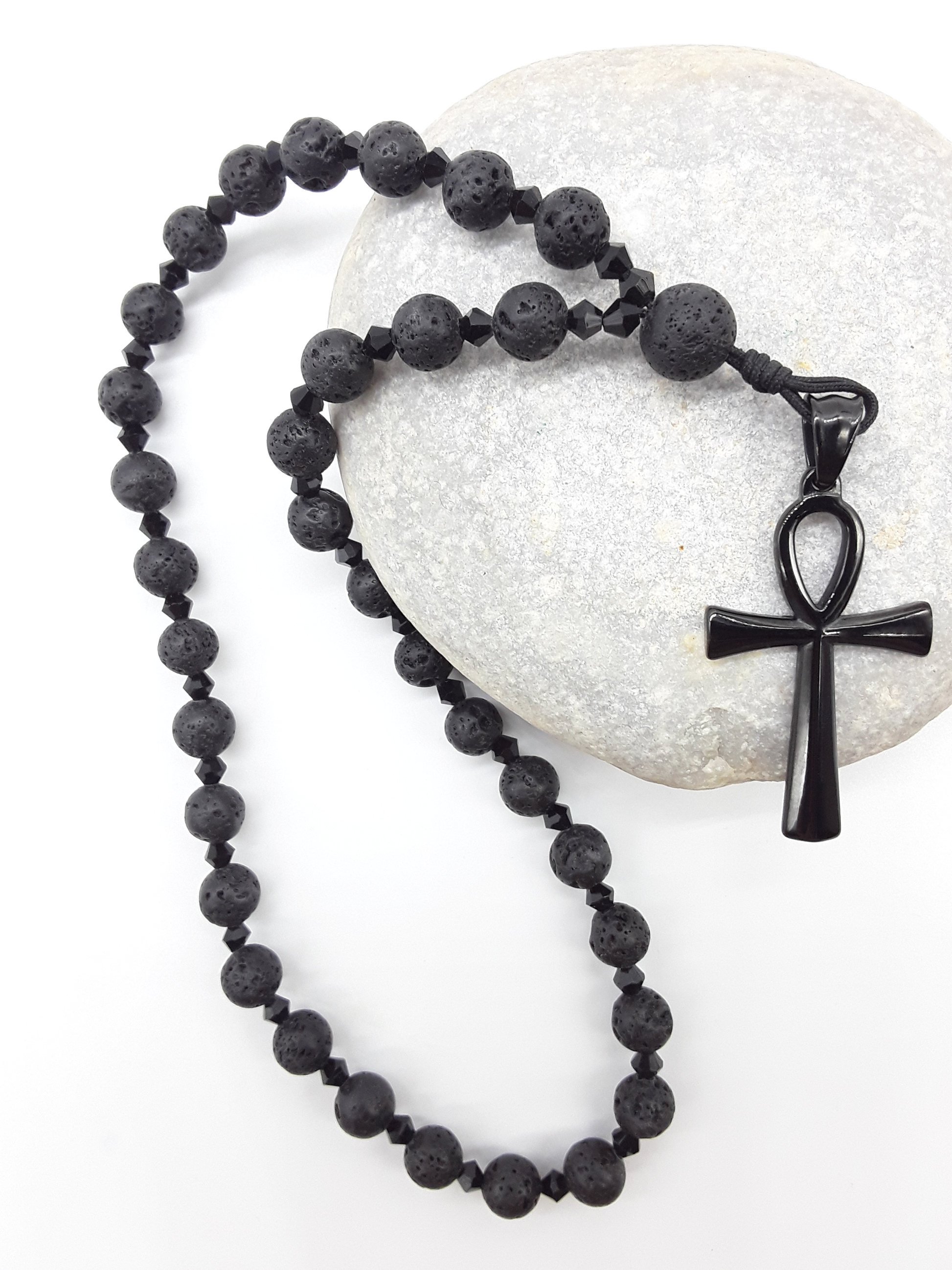 Lava and black crystal Orthodox Rosary resting on natural stone surface with Ankh cross by Polmadeva.
