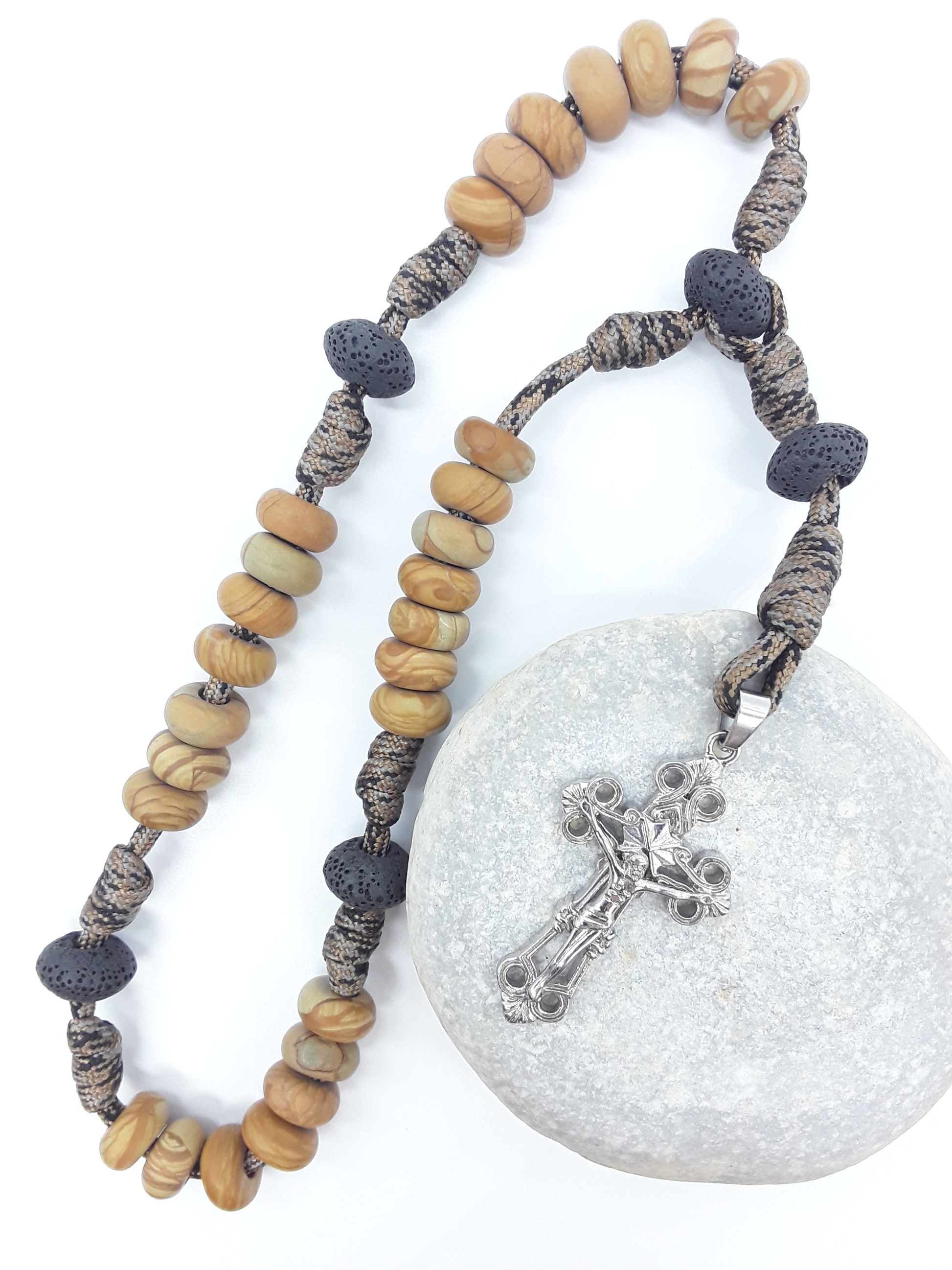 The Grounded Path — Natural Wood and Lava Stone Paracord Anglican Prayer Beads with stainless steel Cross by Polmadeva resting on natural stone.
