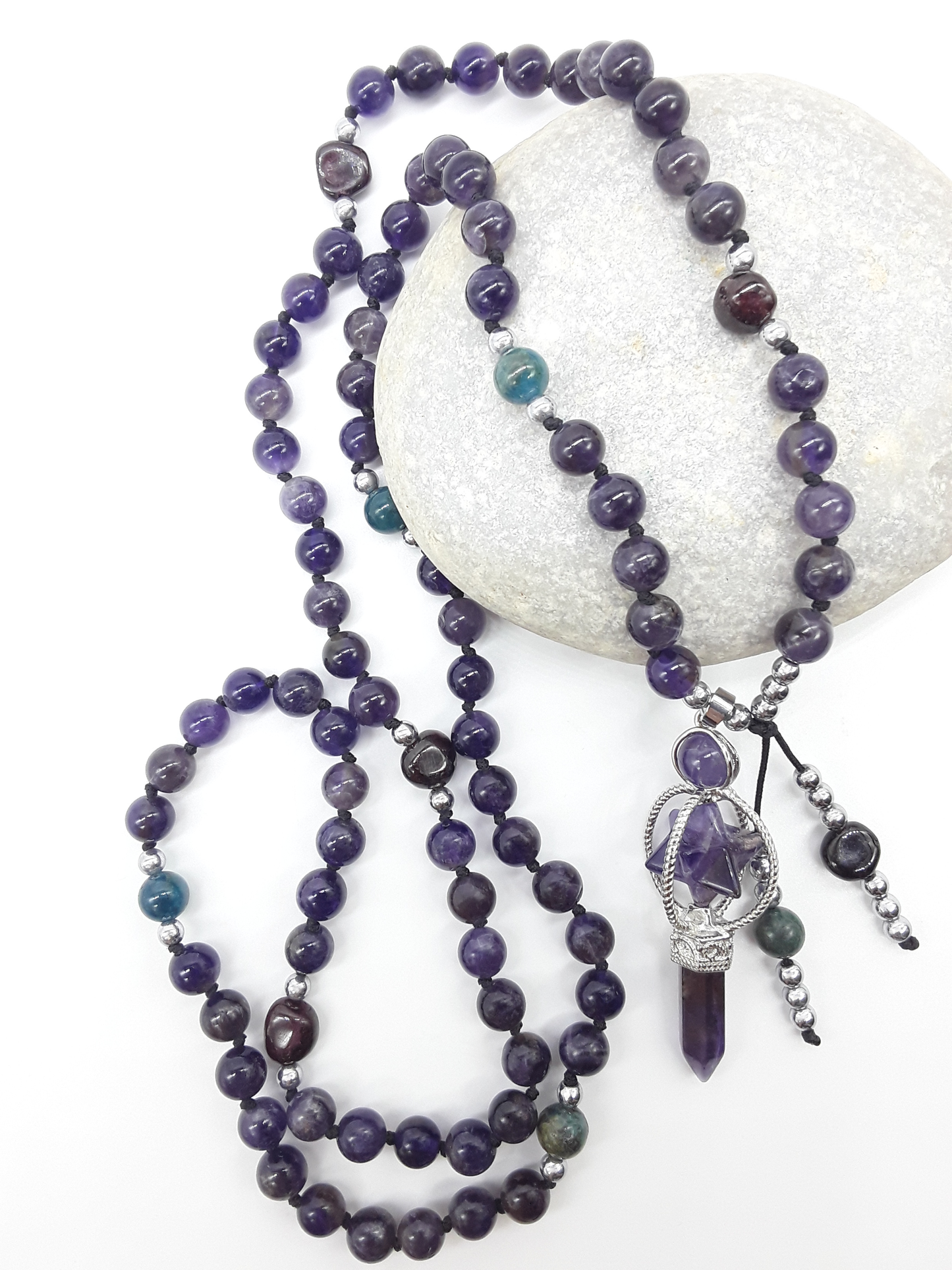Amethyst and Apatite Mala Beads with Natural Amethyst pendant arranged on white stone, Polmadeva