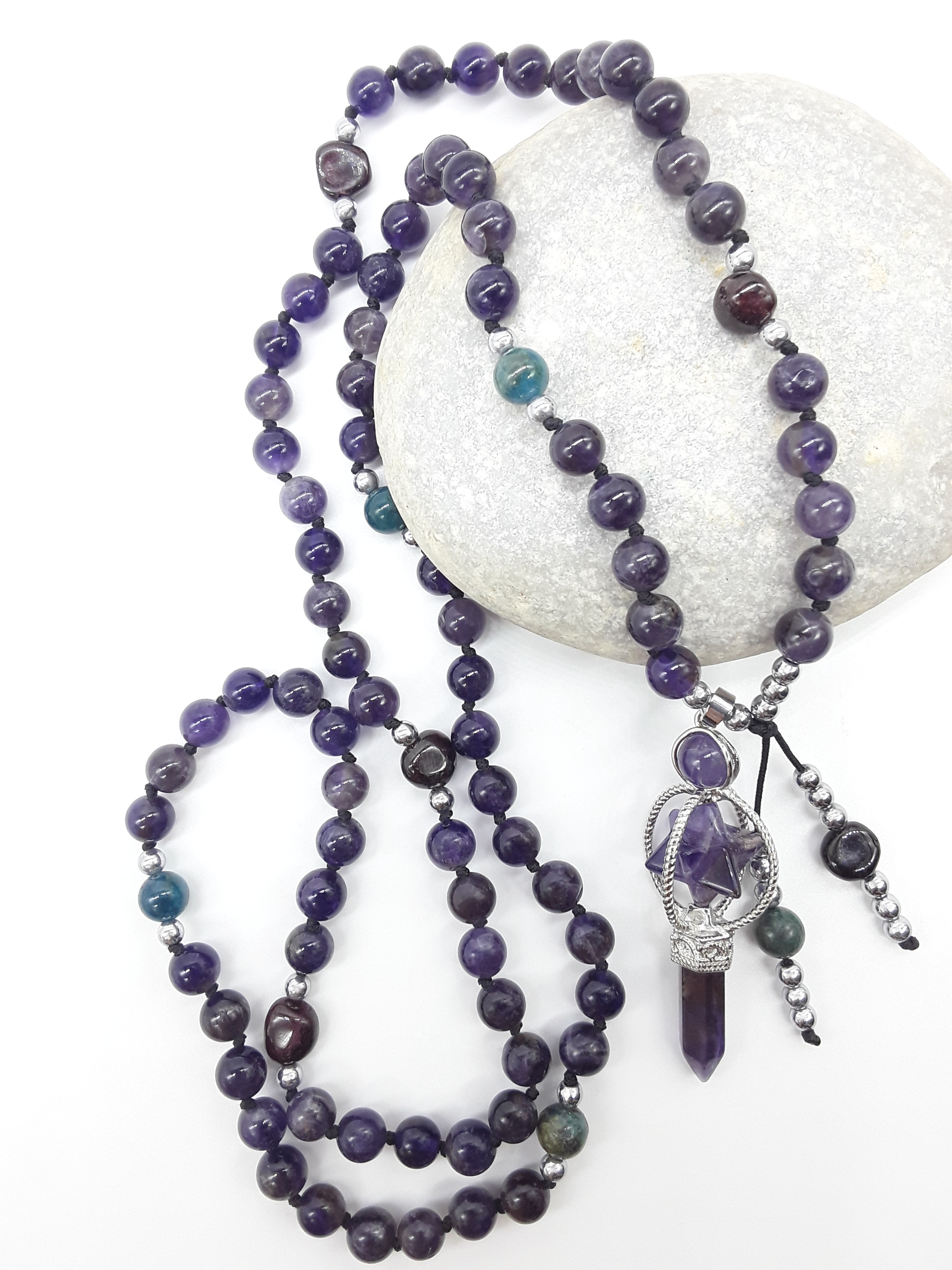 Amethyst and Apatite Mala Beads with Natural Amethyst pendant arranged on white stone, Polmadeva