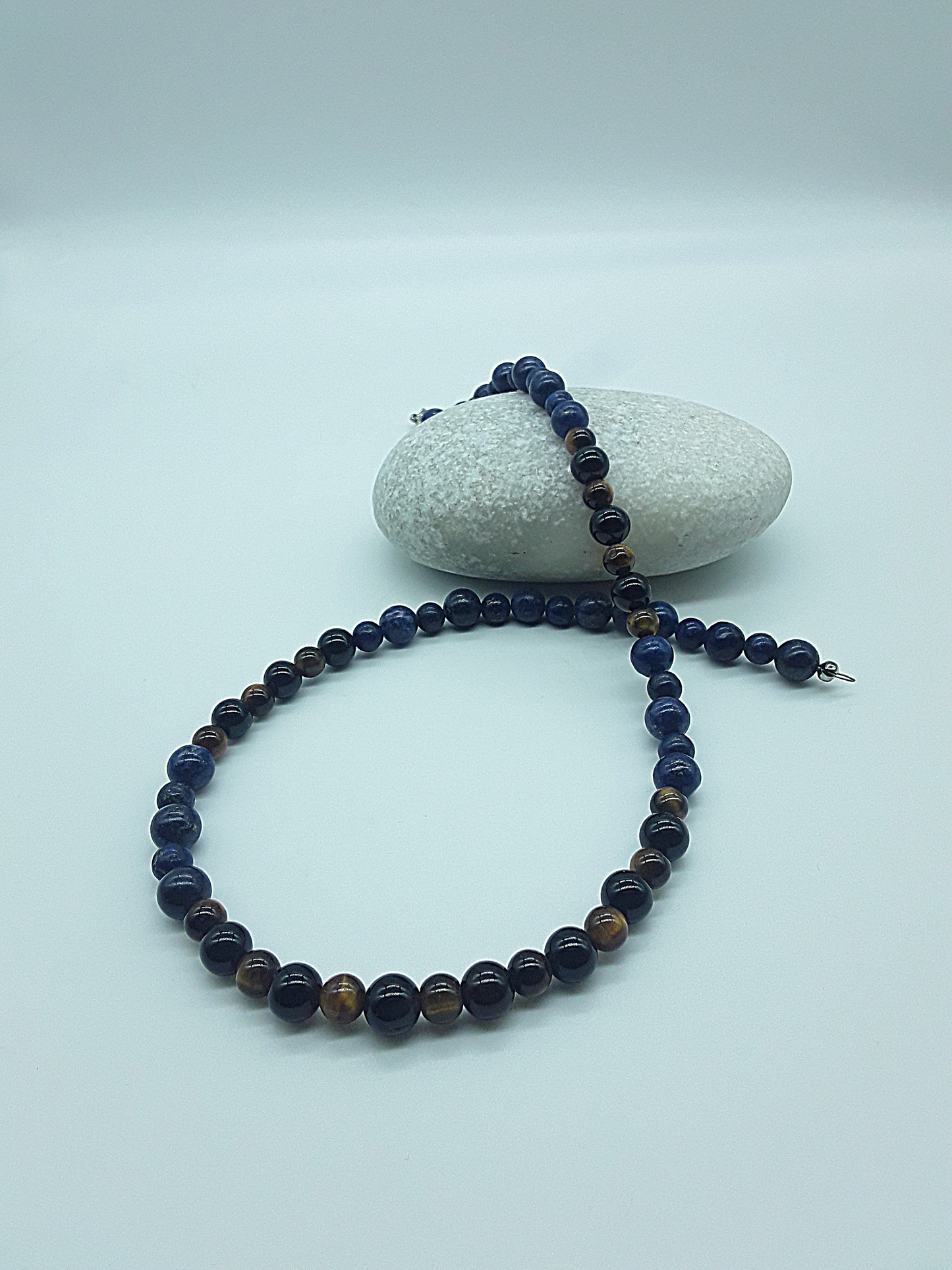 Polmadeva Inner Sight Necklace with lapis lazuli, tiger’s eye and black onyx beads styled on stone, Soul Vision collection
