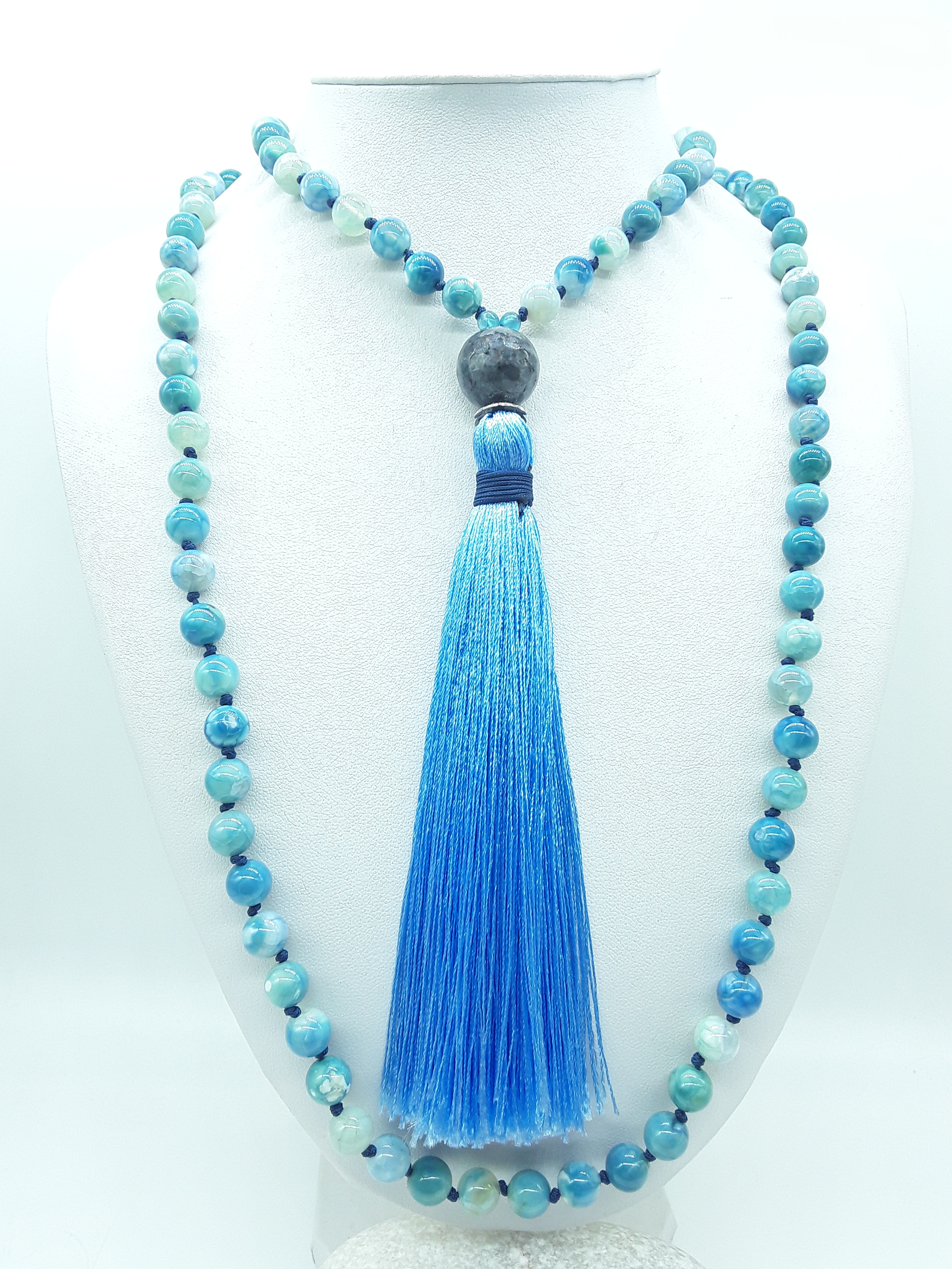 Agate and Labradorite Mala Beads with blue tassel arranged in open flowing form on white background, Polmadeva
