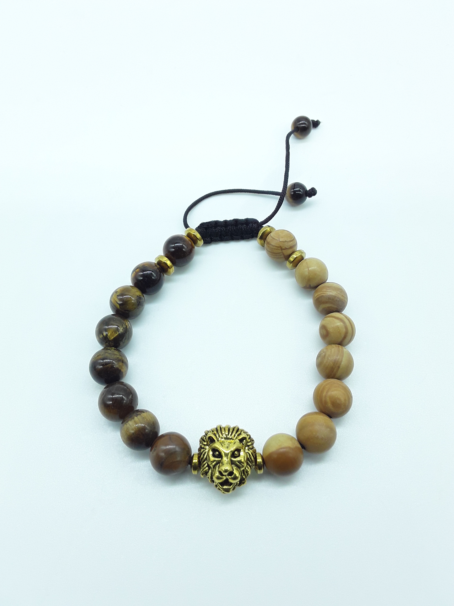 Unmoved Flame bracelet with Carnelian beads and metal lion centerpiece on a light neutral background