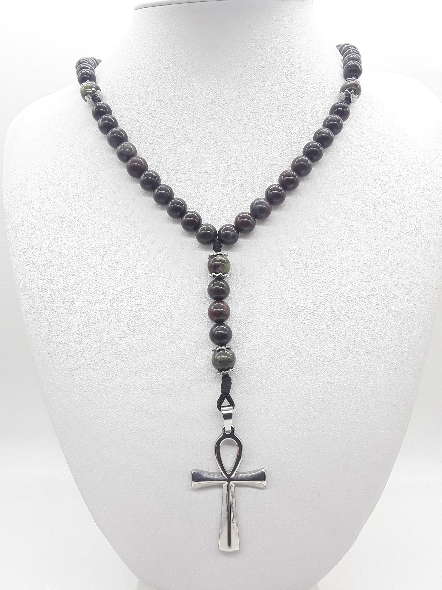 Catholic rosary made of bloodstone beads with stainless steel Ankh cross displayed on mannequin bust