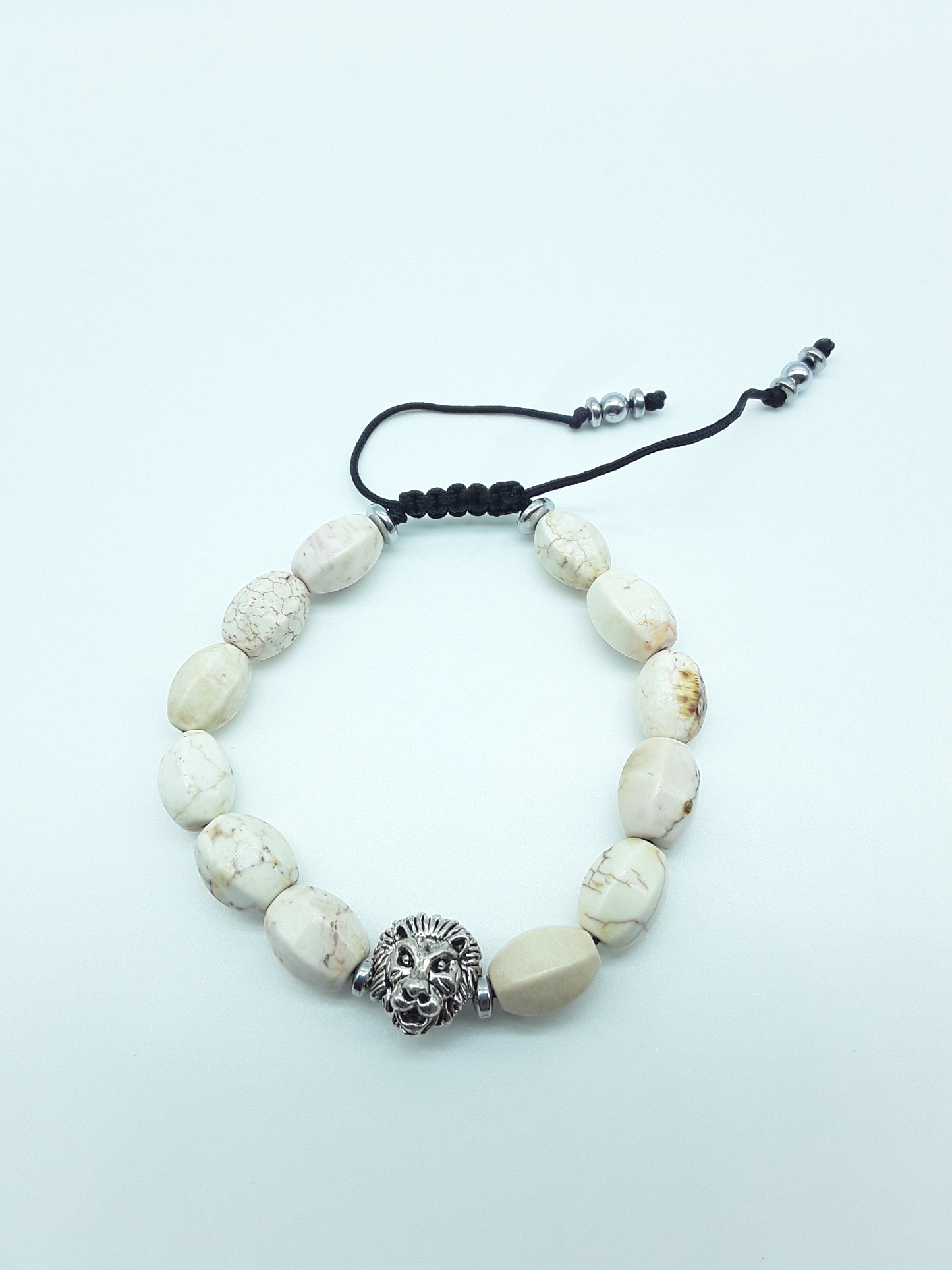 Ivory Turquoise lion bracelet with 10mm natural gemstones and adjustable cord on a white background