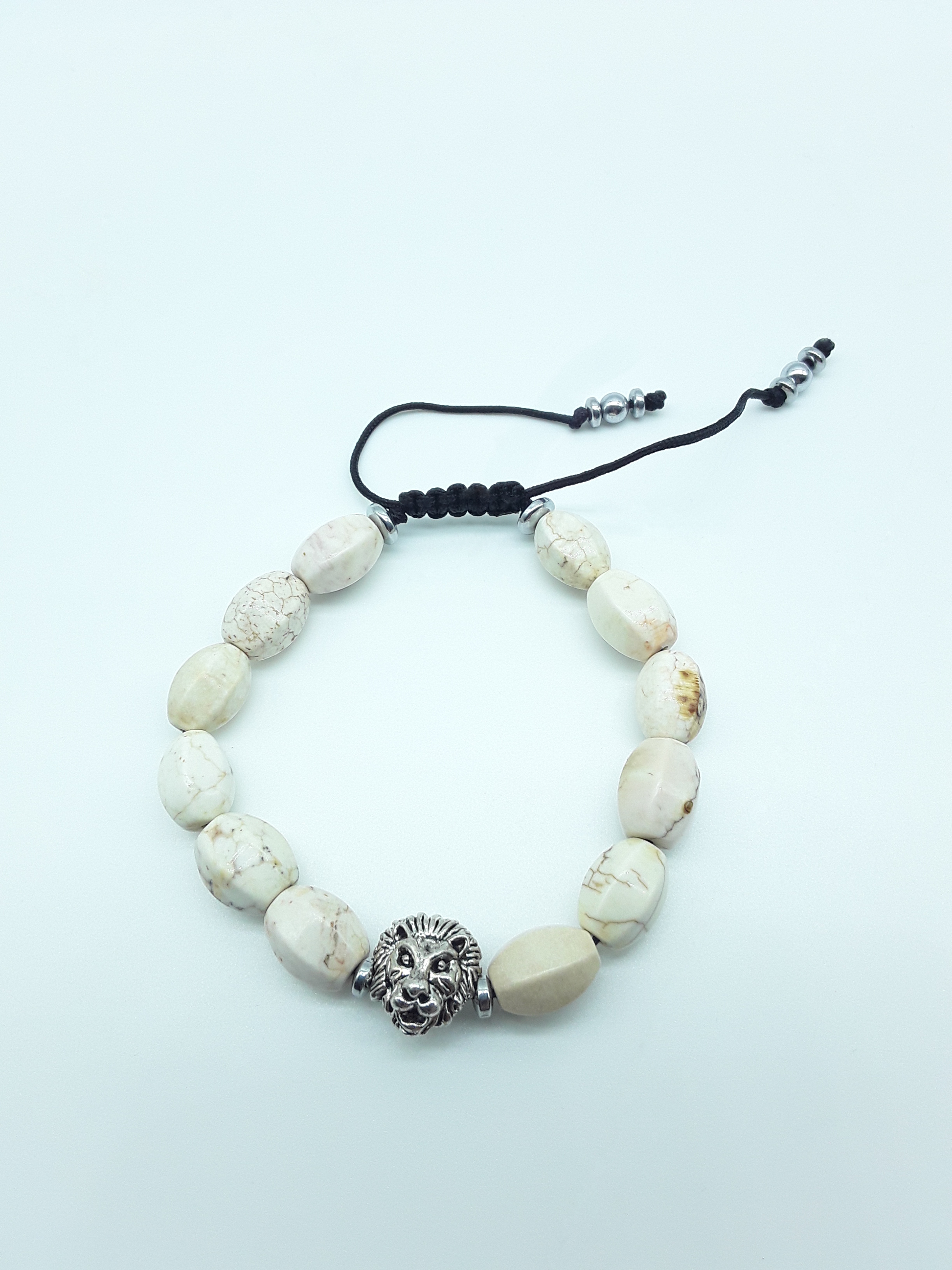 Ivory Turquoise lion bracelet with 10mm natural gemstones and adjustable cord on a white background