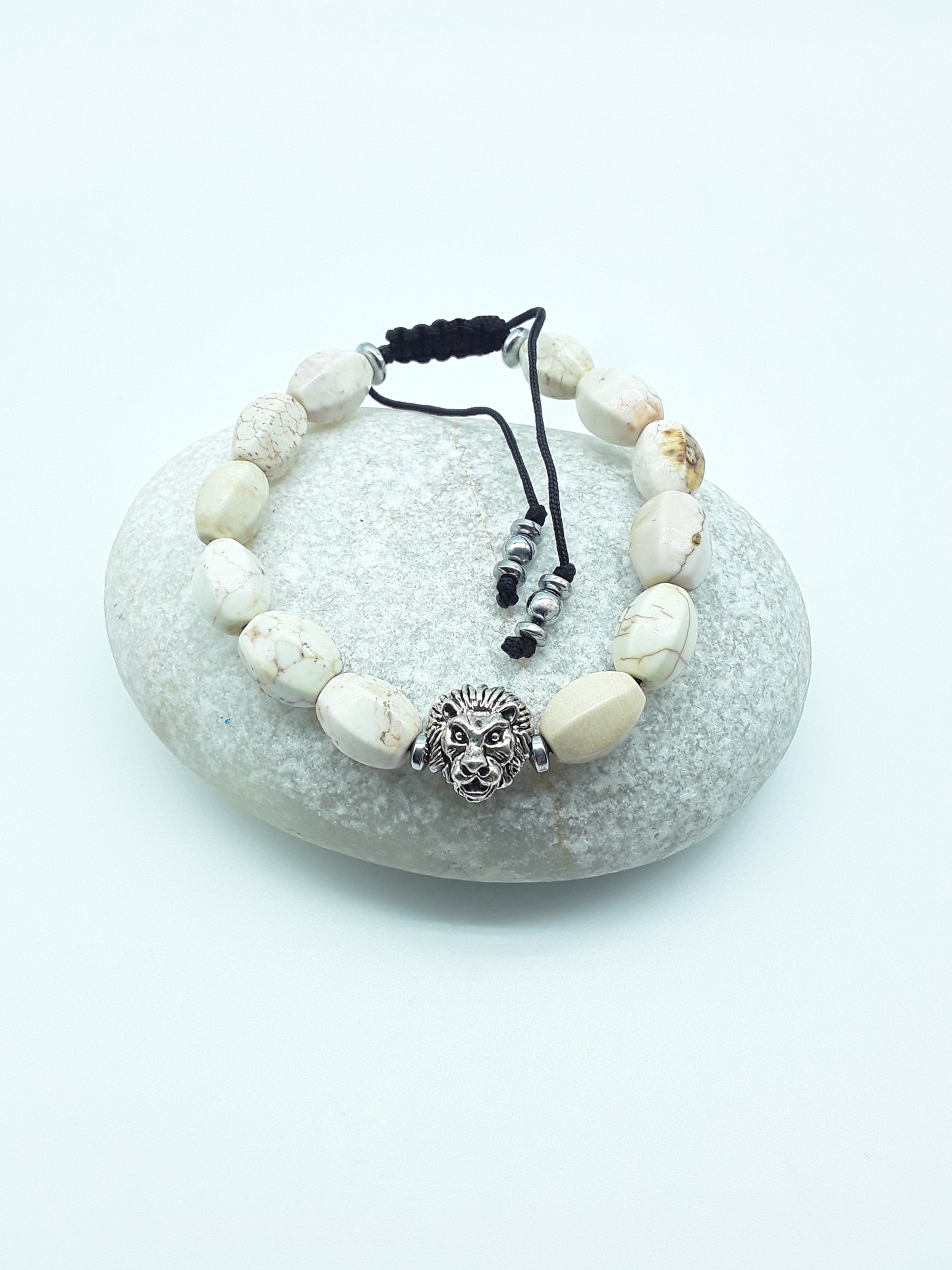 Ivory Turquoise lion bracelet placed on a natural stone, symbolizing calm strength and quiet protection