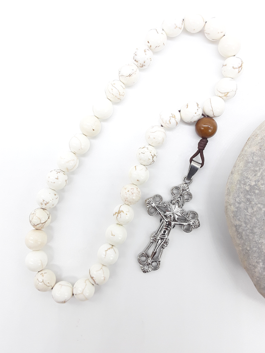 Magnesite Paracord Orthodox Rosary with silver crucifix beside natural stone surface by Polmadeva.