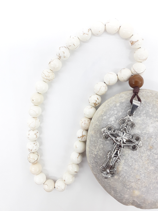 Magnesite Paracord Orthodox Rosary resting on natural stone surface with silver crucifix by Polmadeva.