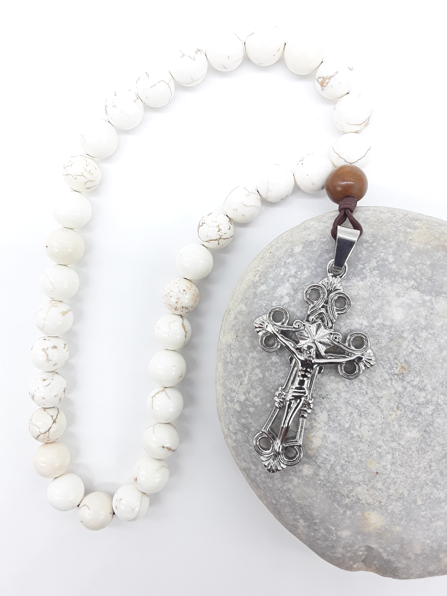 Magnesite Paracord Orthodox Rosary resting on natural stone surface with silver crucifix by Polmadeva.